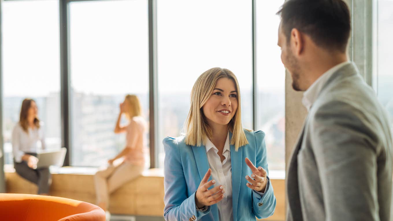 man talking to female colleague noticing her energy