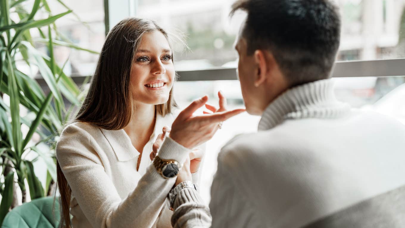 woman gesturing with her hands during conversation