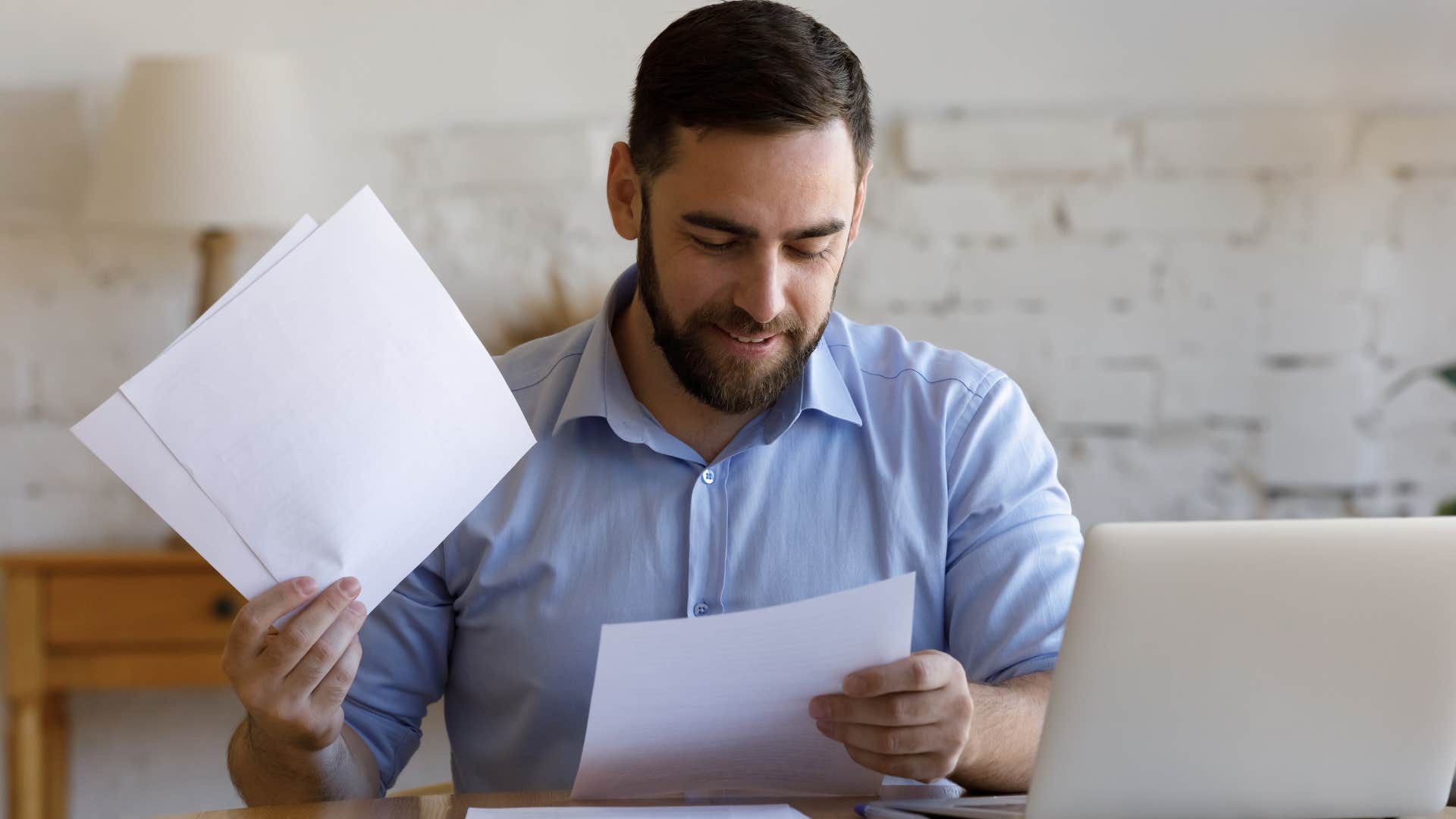 man looking at papers 