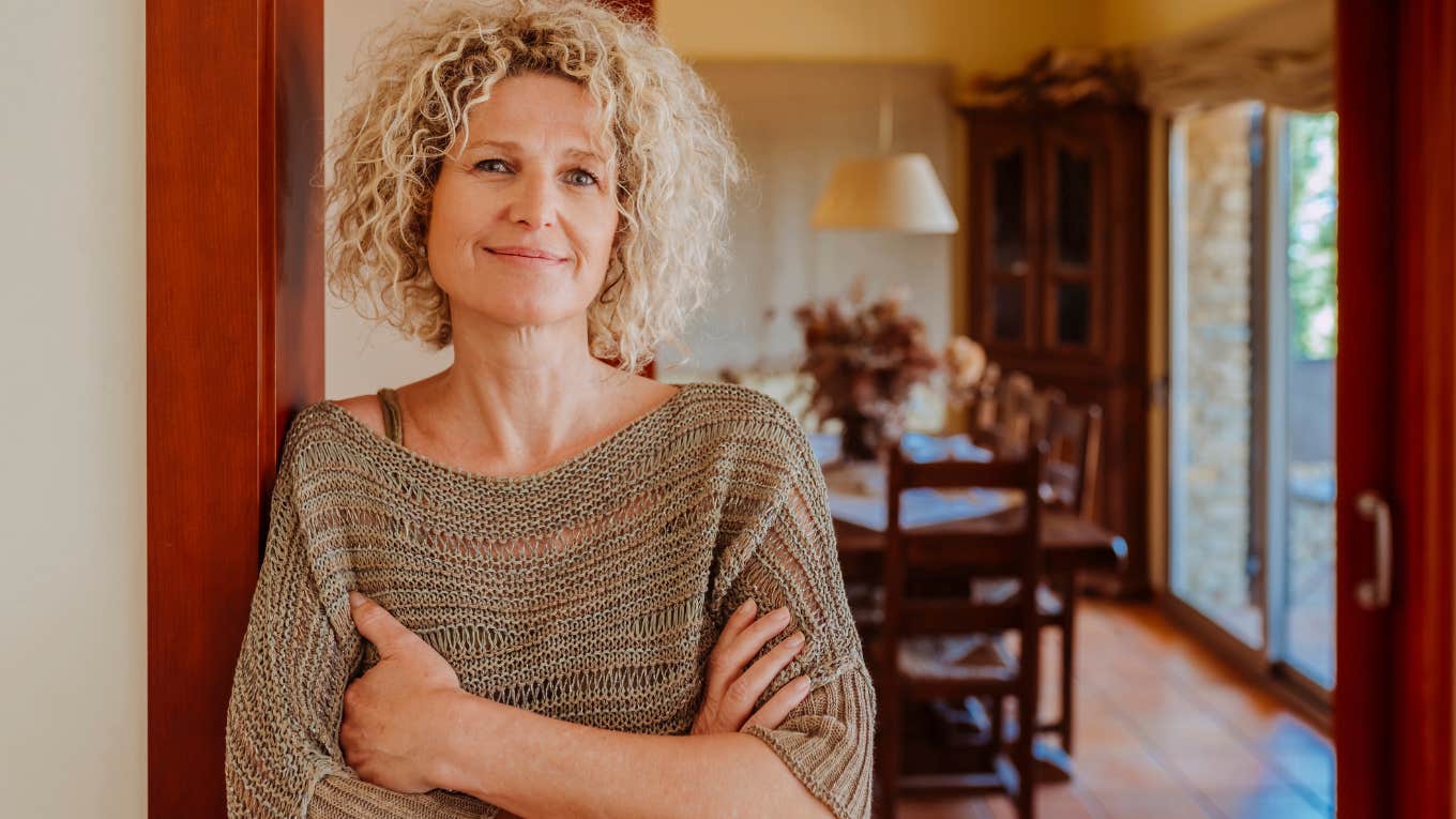 Things The Most Successful People Always Have In Their Homes successful woman standing in doorway of her home
