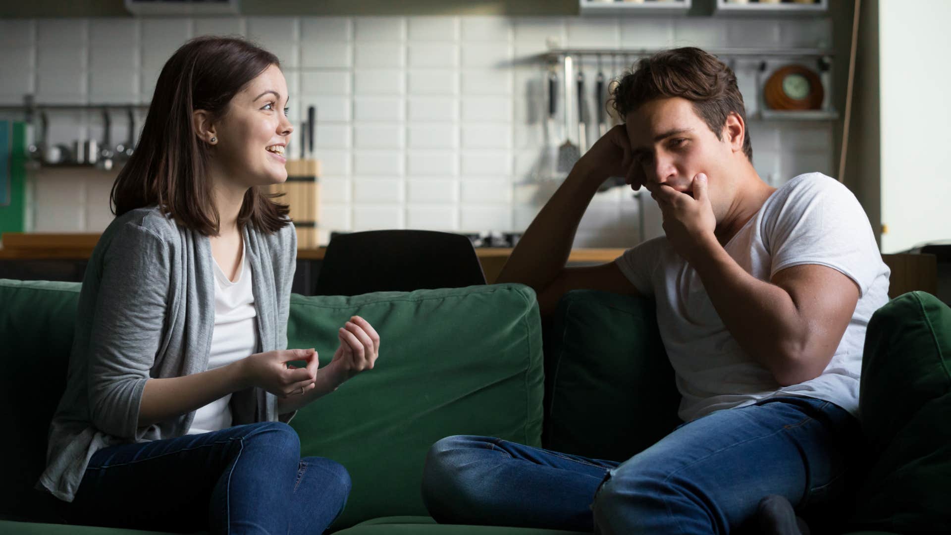 man bored yawning by girlfriend gossiping