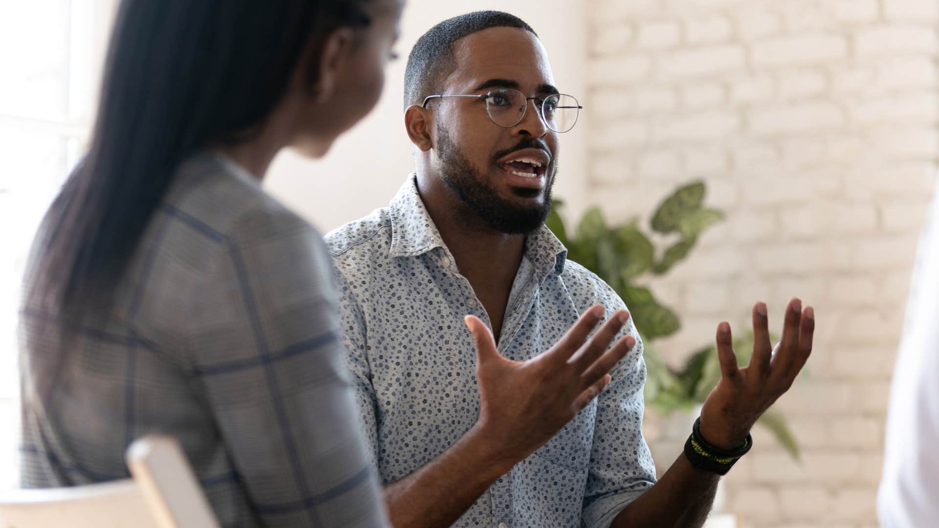 Man who's a chronic complainer talking to co-workers.