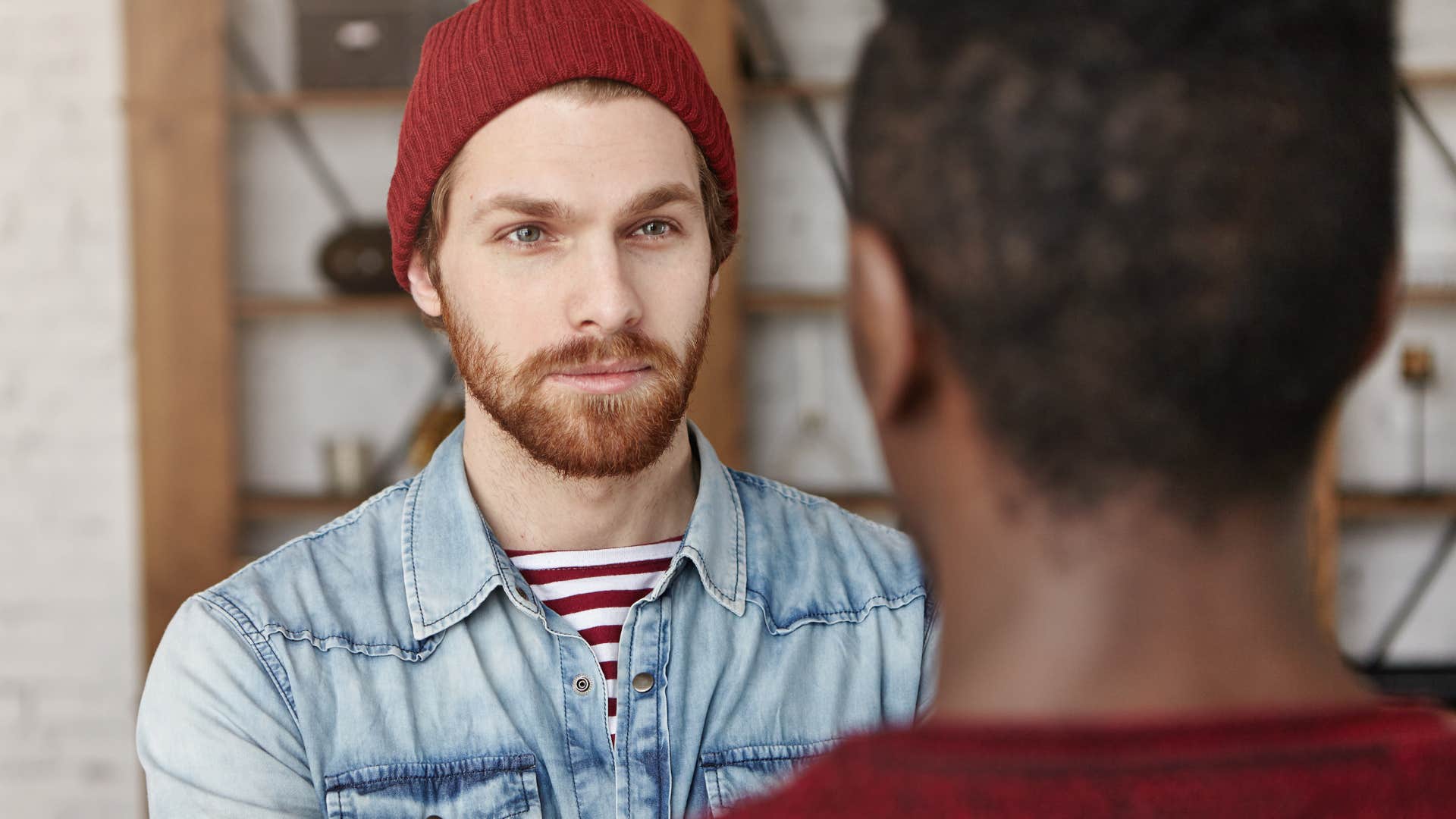 Man being the smart friend while talking to a man.
