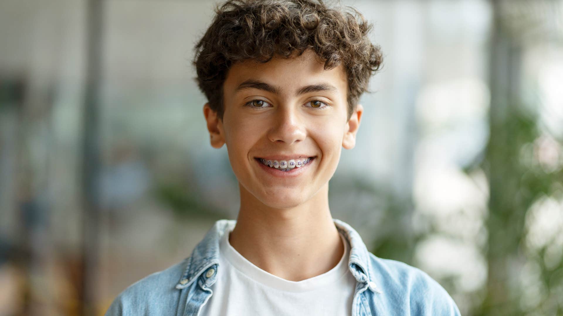 Teenage boy smiling about getting braces.