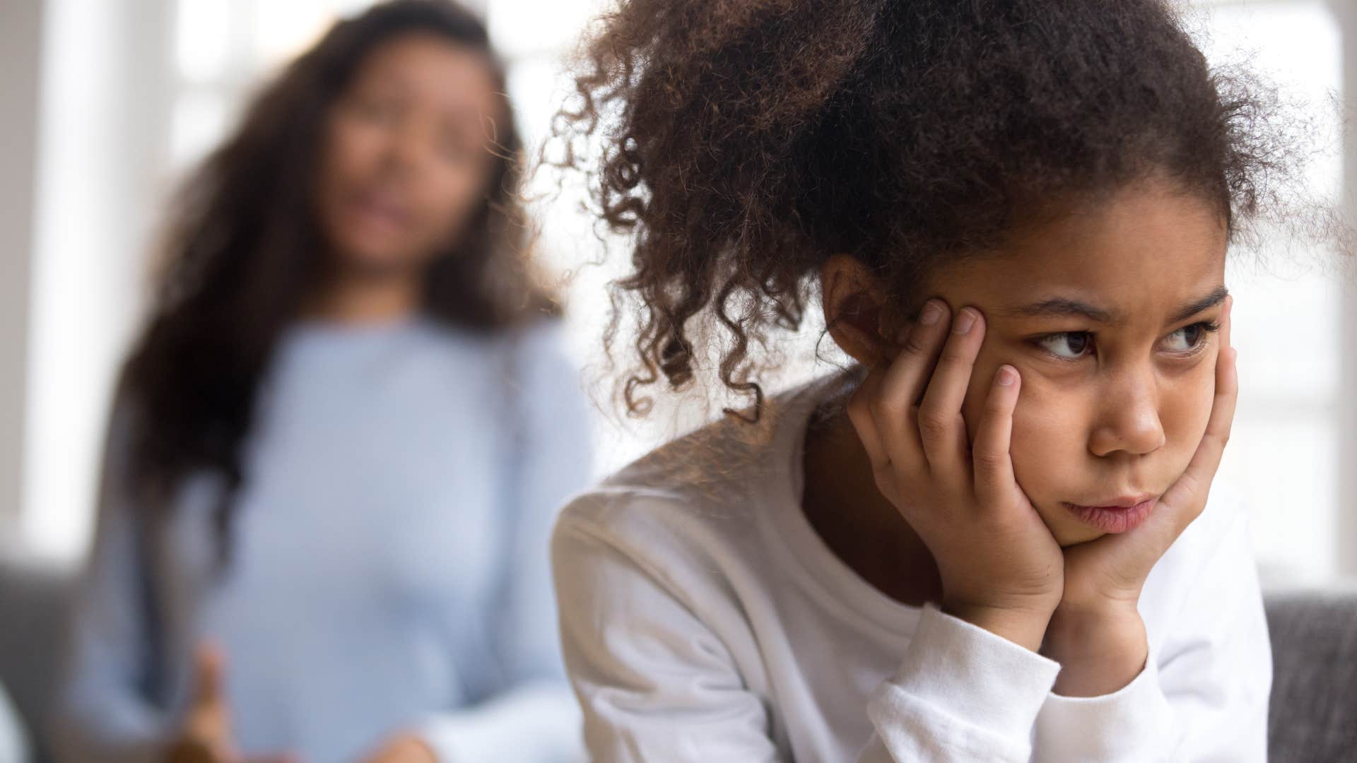 young girl upset with her mom