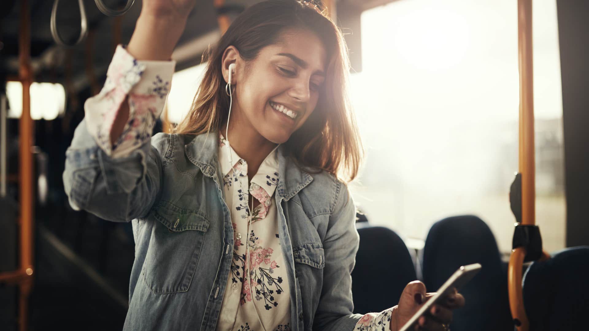 woman playing music out loud on the bus