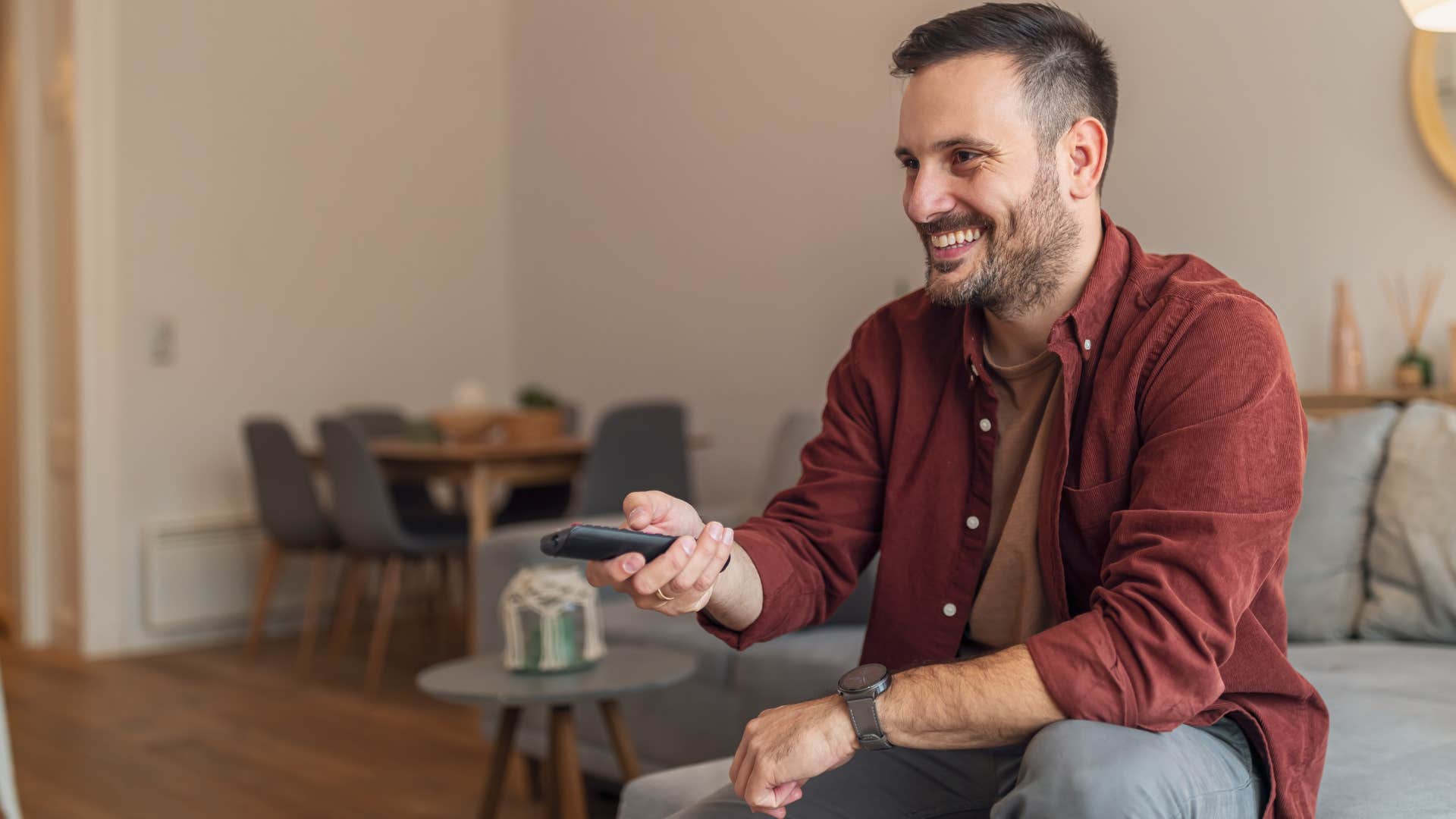 man with numerous subscriptions watching TV at home