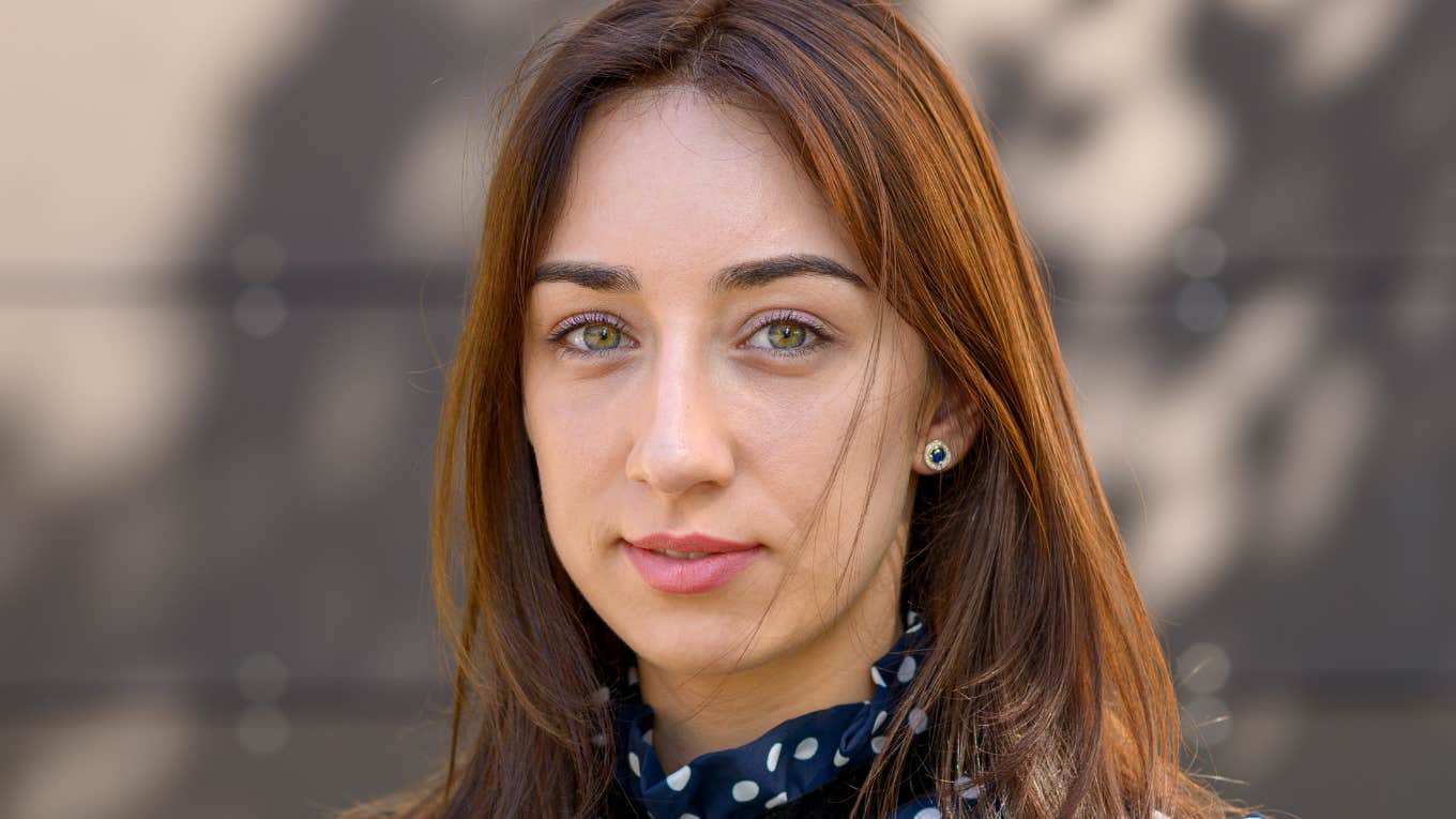 serious woman who grew up poor being frugal
