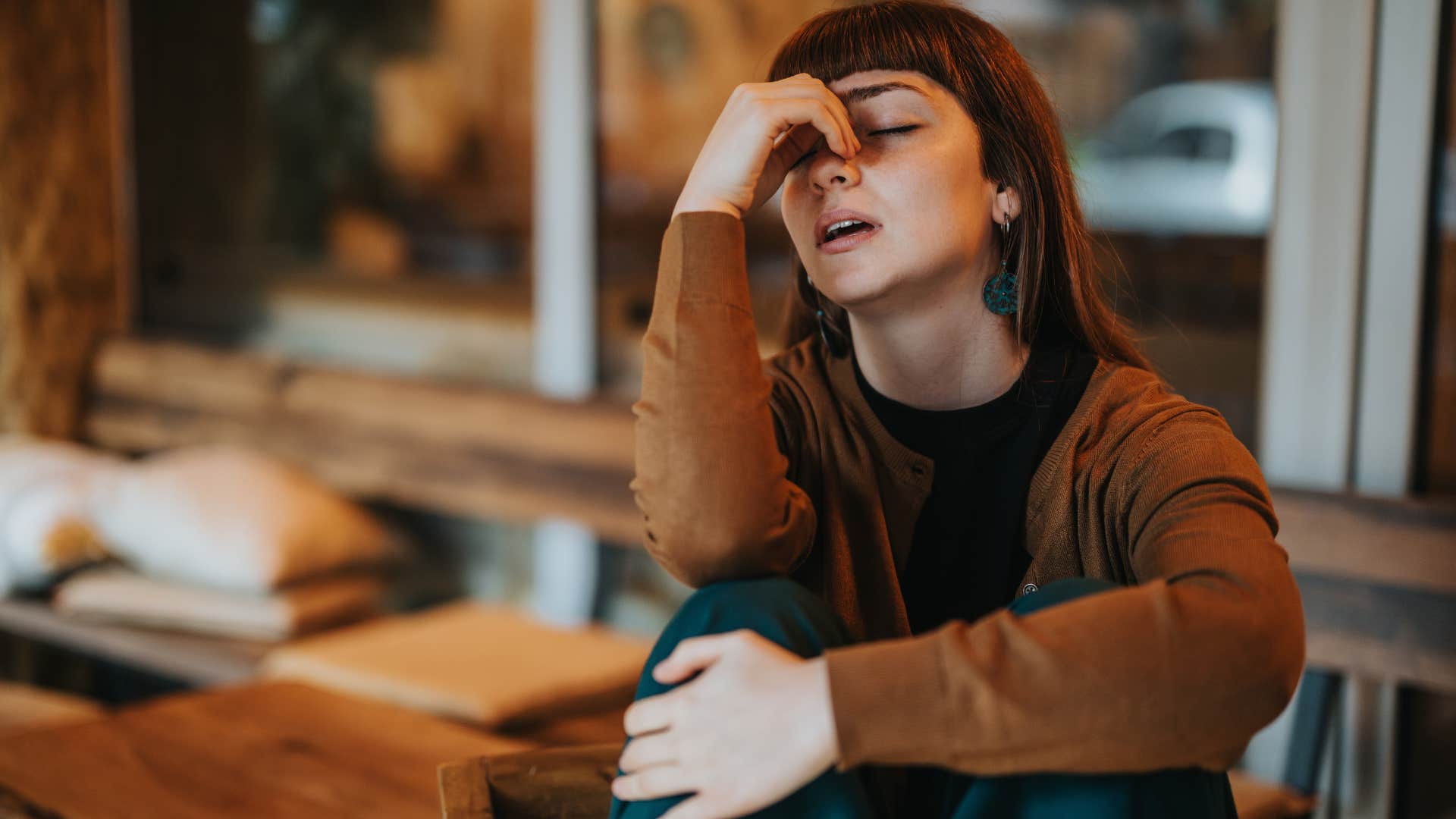 stressed woman sitting outside of crowded public spaces