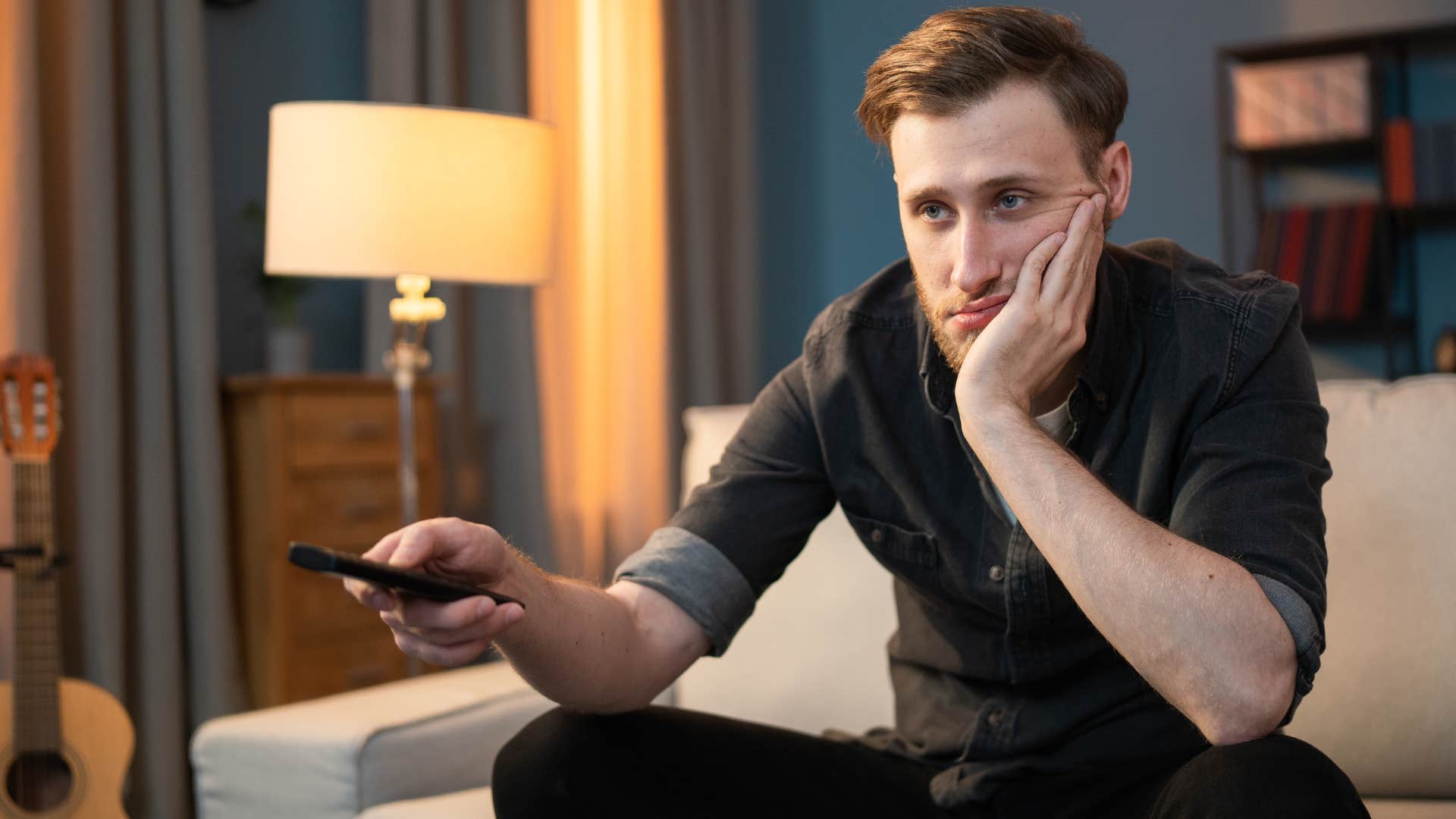 man complaining about streaming services with a remote in his hand