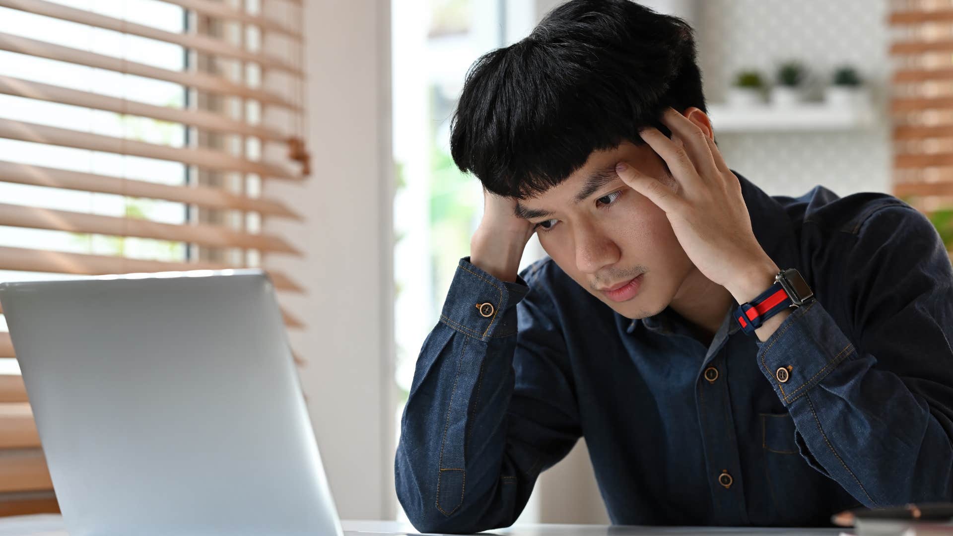 Man complaining about work on his laptop.
