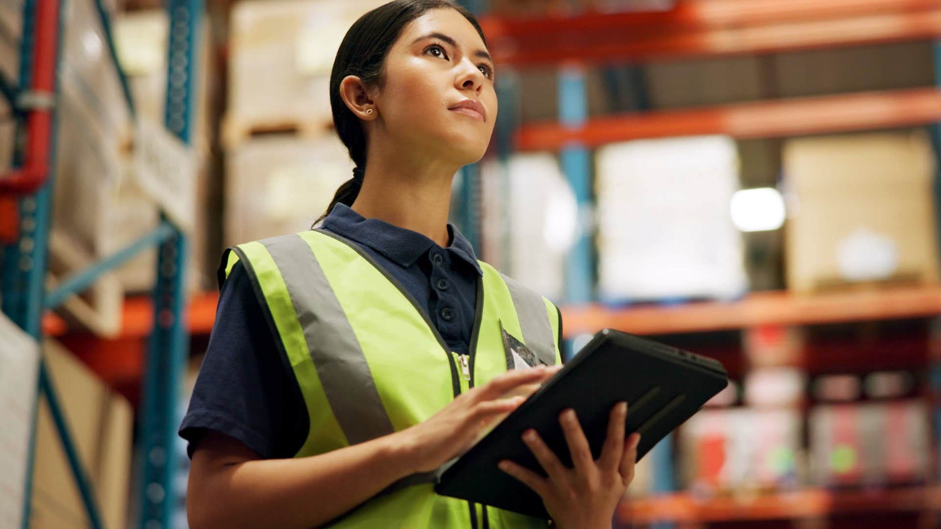 Woman who's not going to college working in a warehouse.
