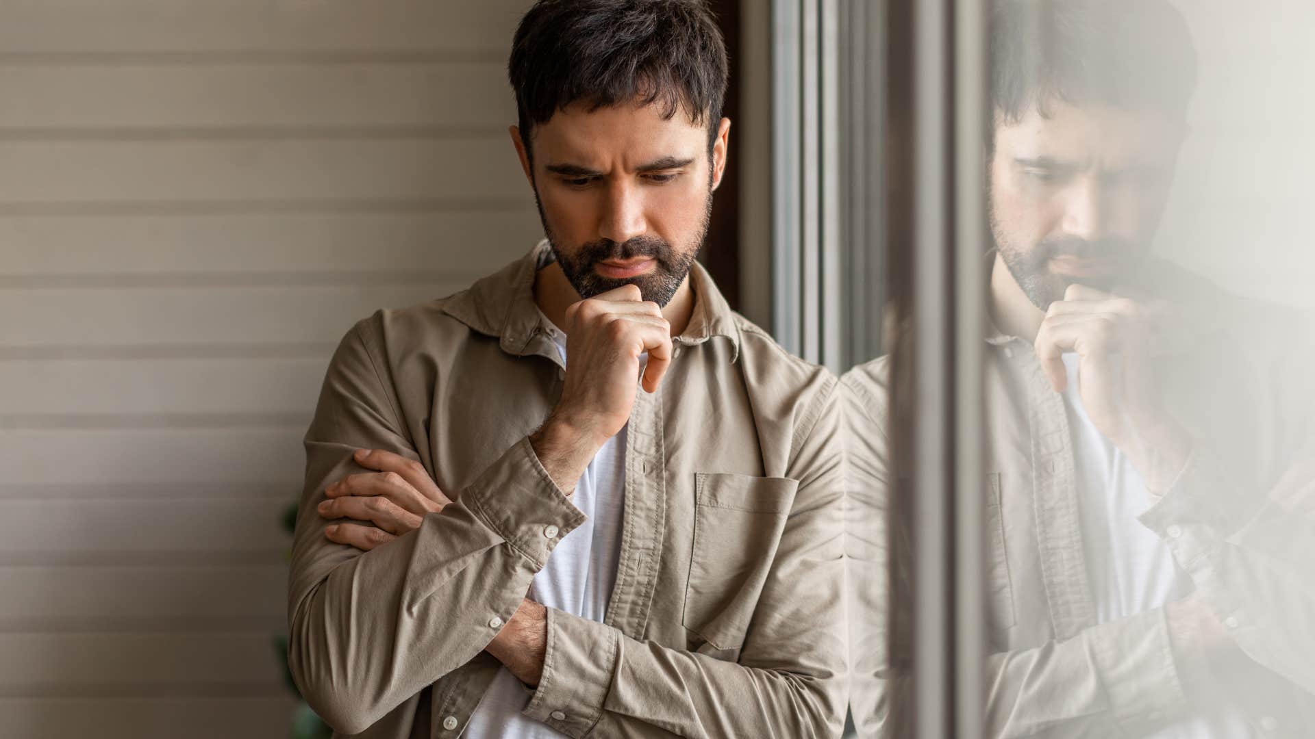 Man who disliked being unemployed looking serious at home.