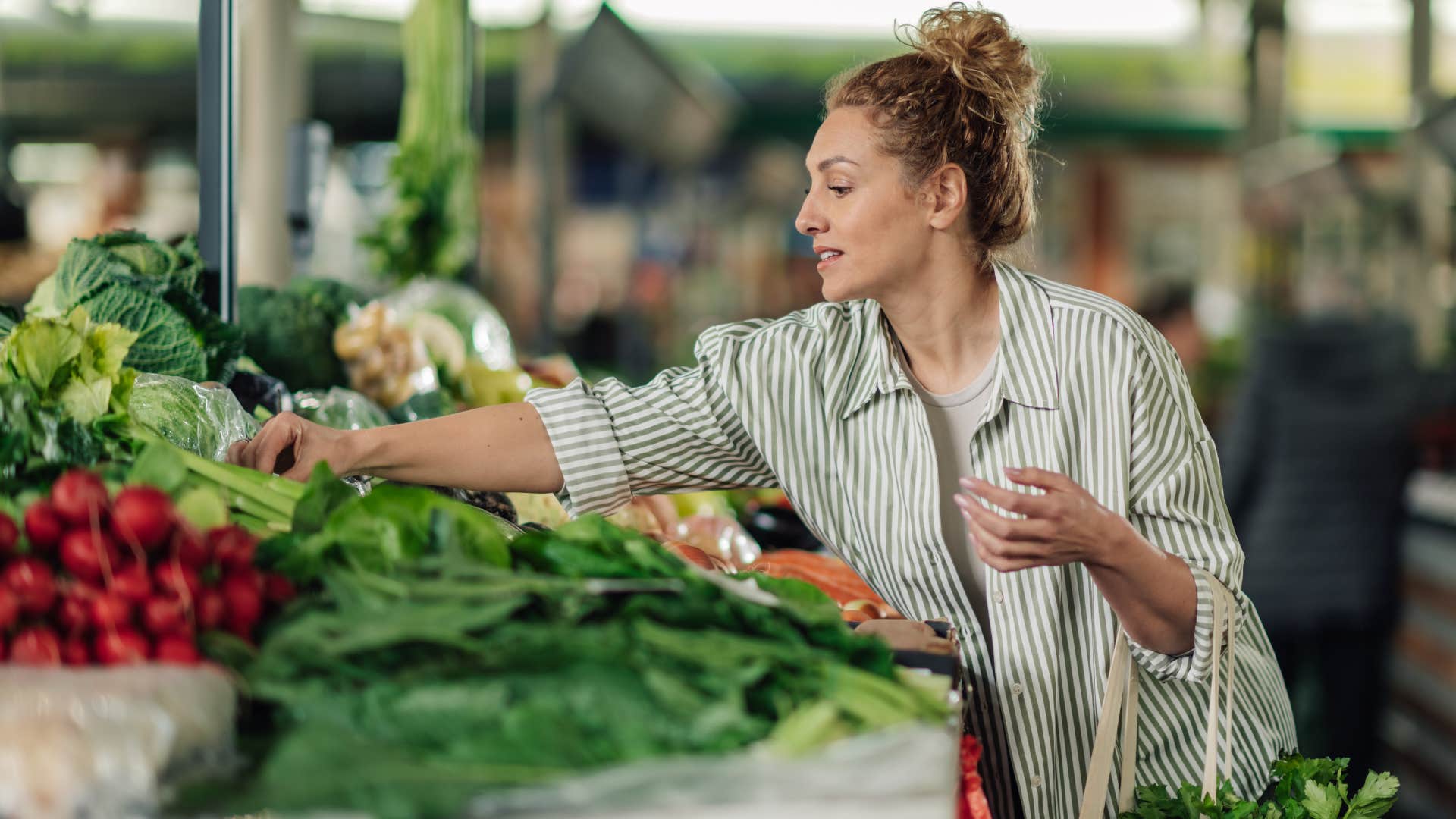 frugal woman shopping for vegetables at the grocery store