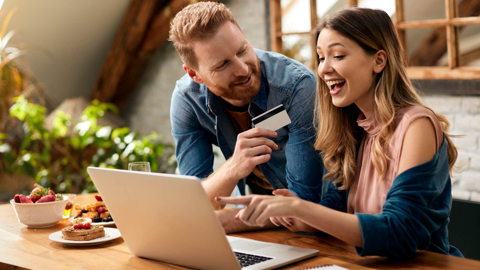 financially stressed woman saying I'd rather enjoy life now to her partner while shopping online