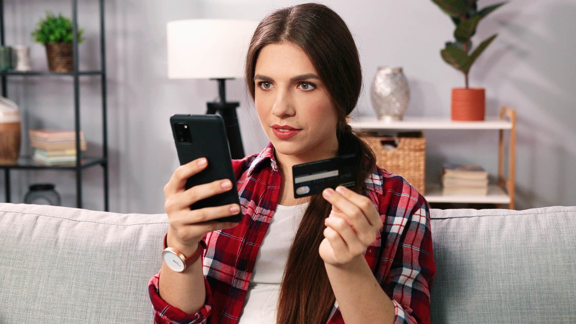 woman thinking I deserve it while buying something on her phone