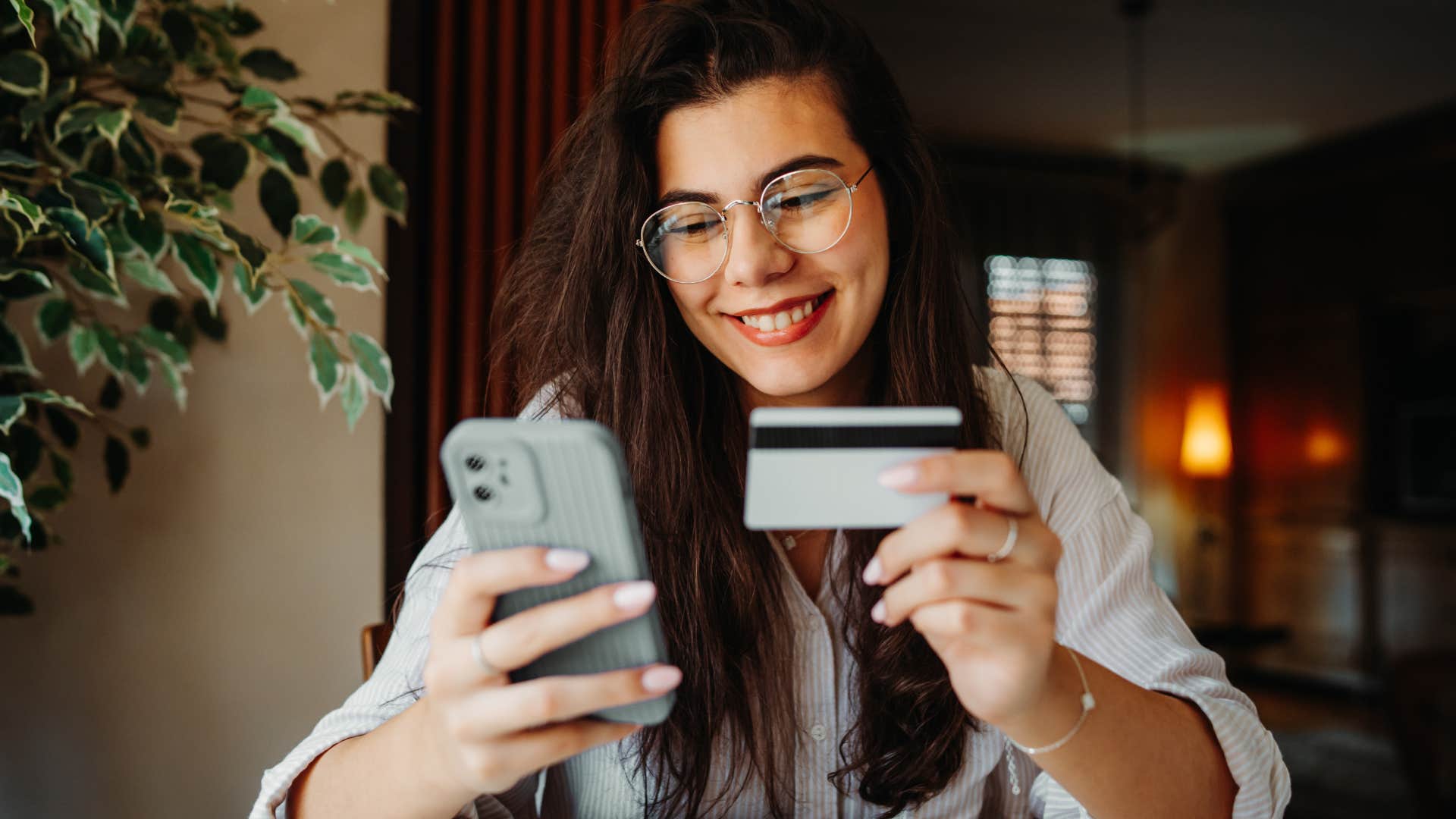 woman smiling and saying it's not a big deal while buying something on her phone