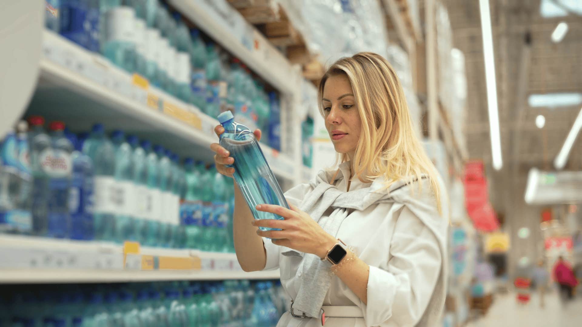 woman buying bottled water before she finally made enough money to know better