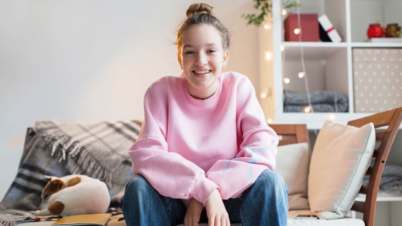 Things People Under 40 Would Never Have In Their Home Even If They Can Afford Them young woman happy in her living room