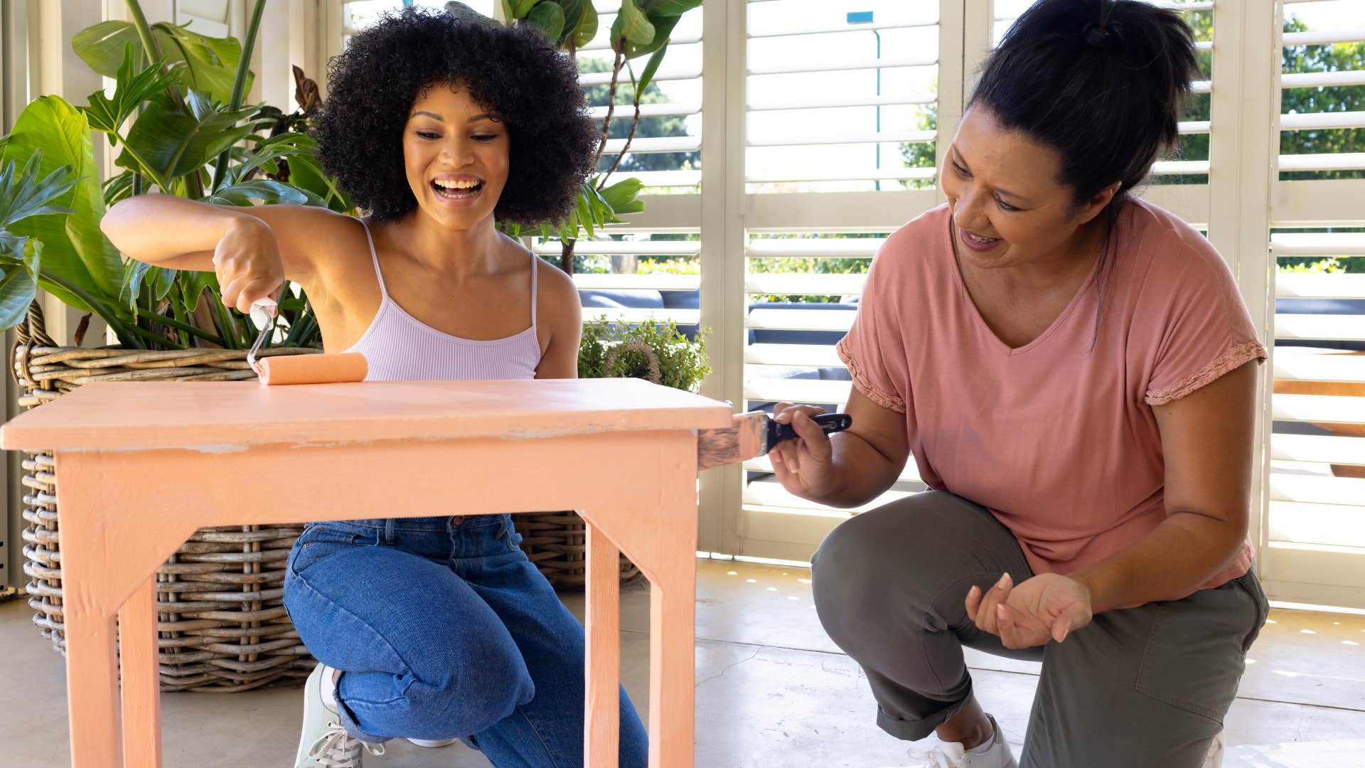 women putting together brand new furniture at home