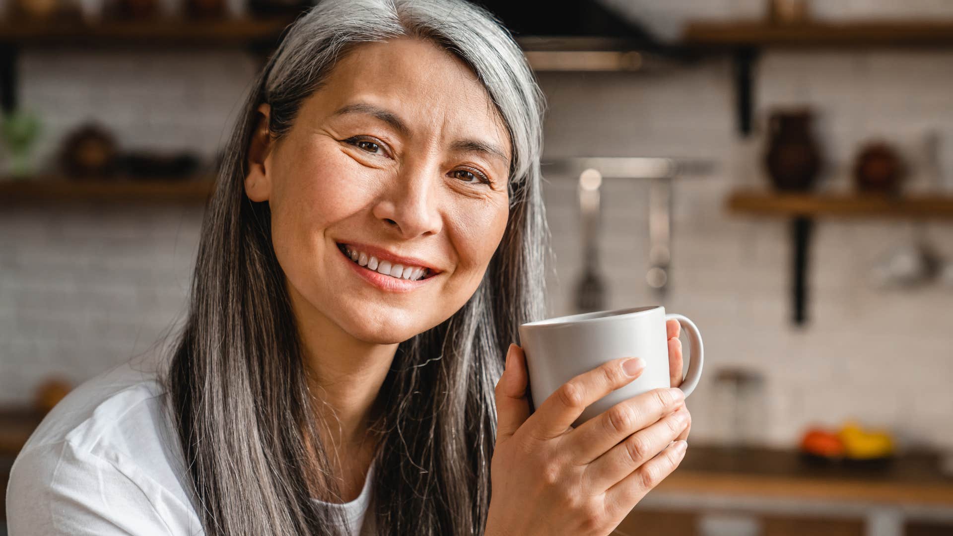 woman drinking coffee with fine china at home