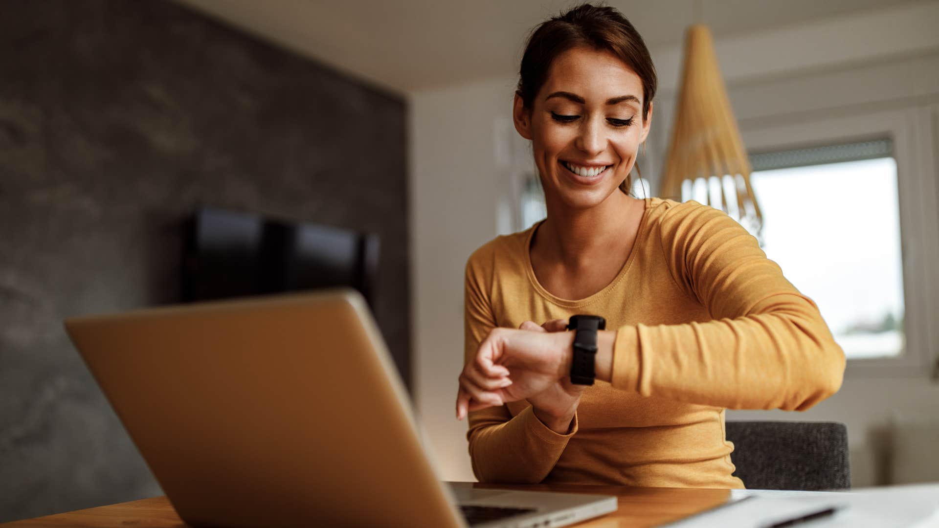 woman using her watch to tell time instead of a grandfather clock