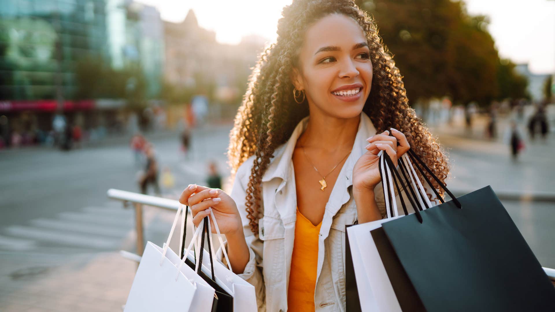 woman holding shopping bags of brand new clothes