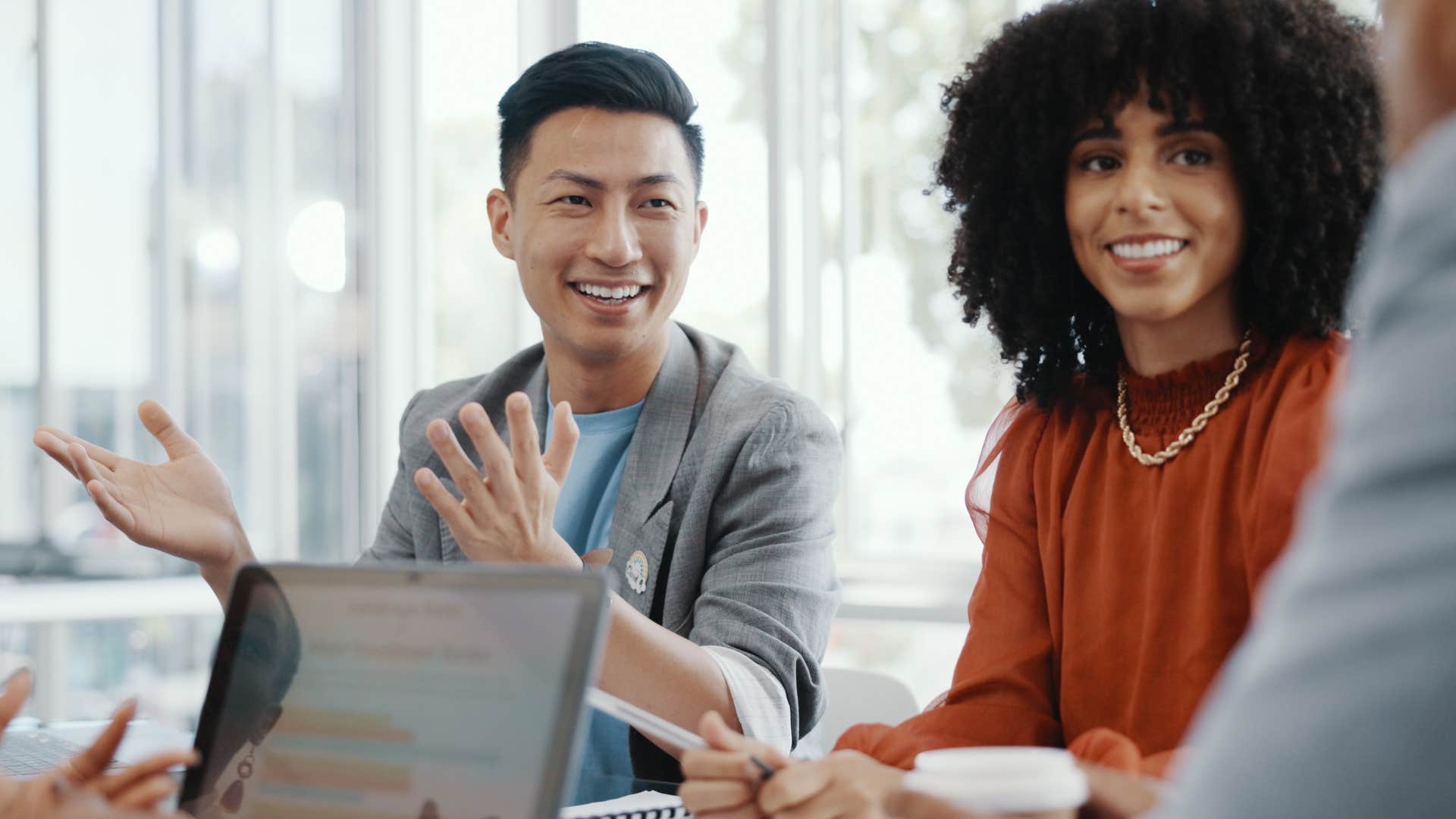 man correcting woman in public in meeting