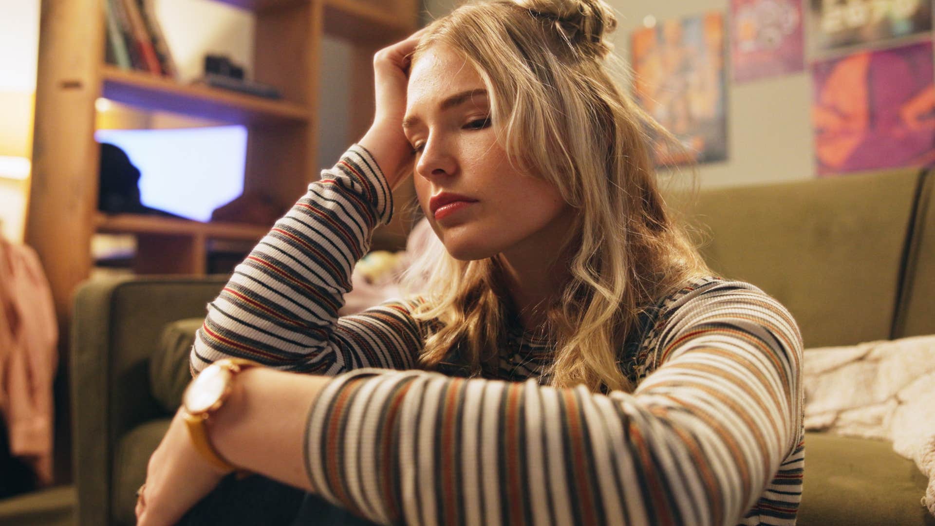 woman exhausted thinking about fake kindness sitting alone in her room