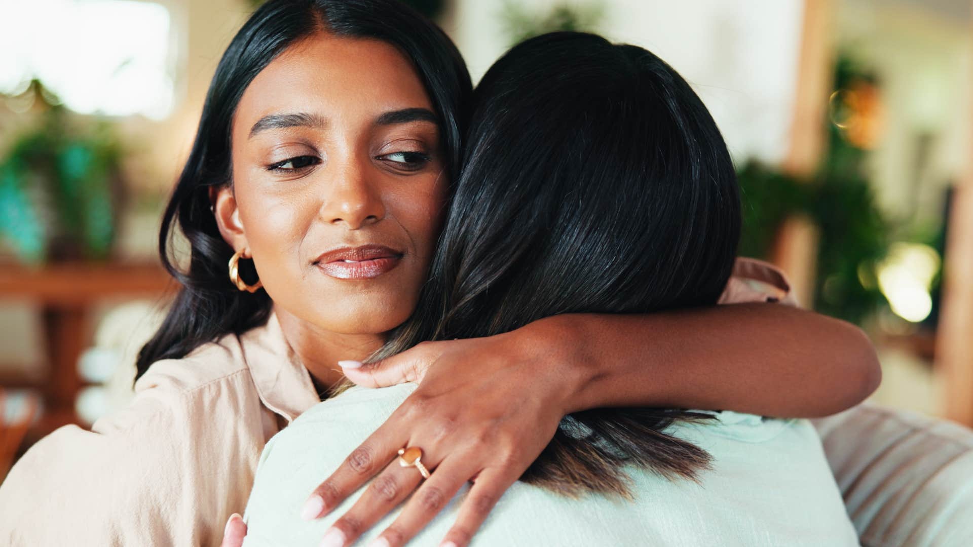 woman with judgmental attitude hugging her friend