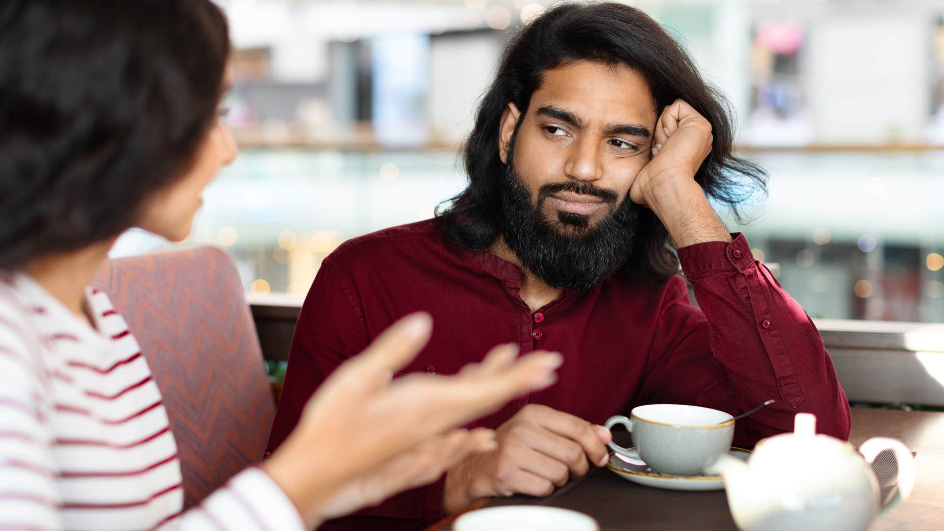 bored man talking to superficial woman