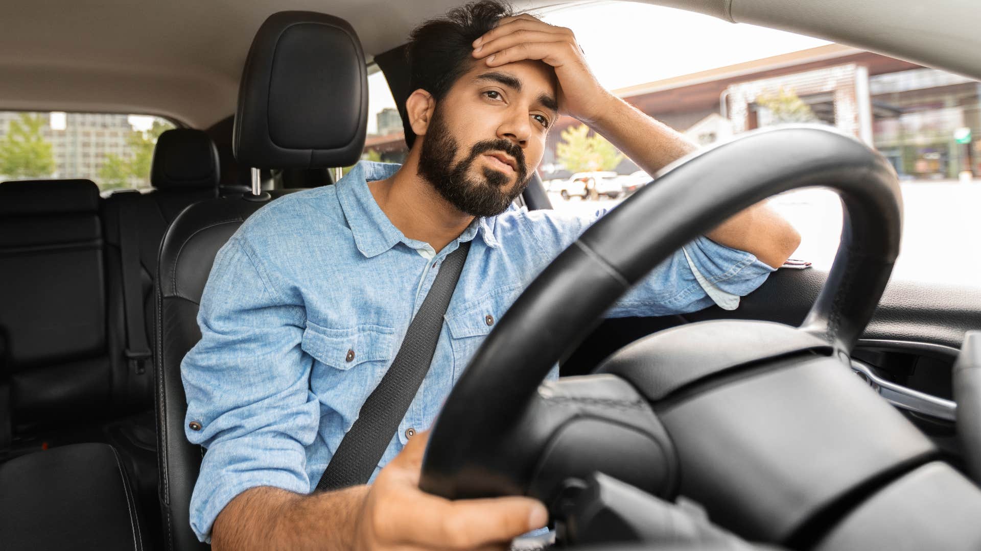 exhausted man thinking about unreliable people while driving