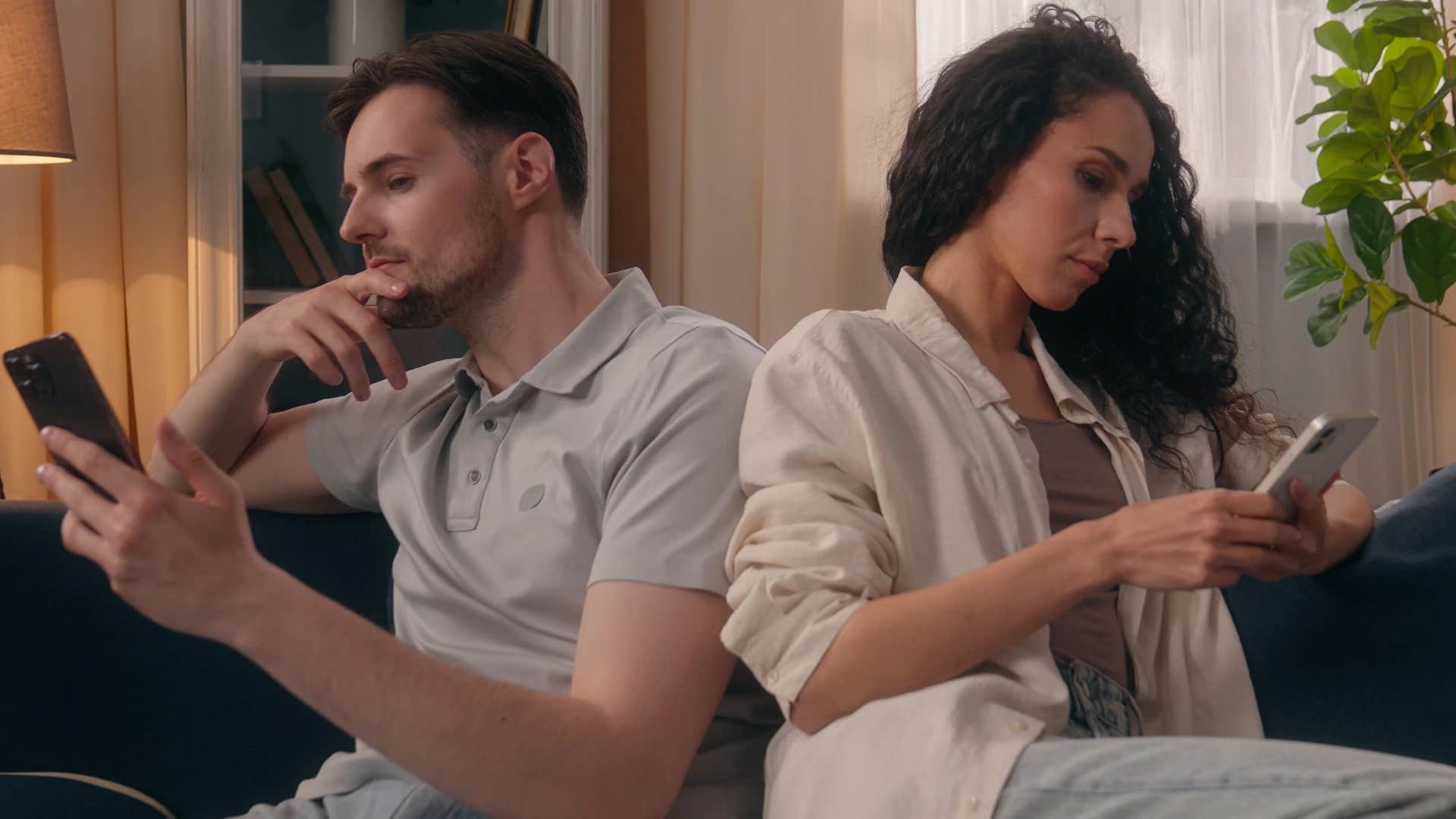couple glued to their phones ignoring each other