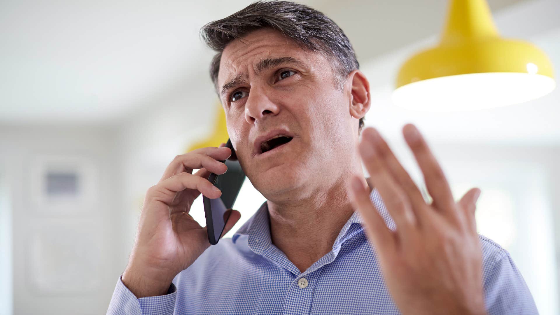 emotionally intelligent annoyed man talking on phone with sarcastic friend