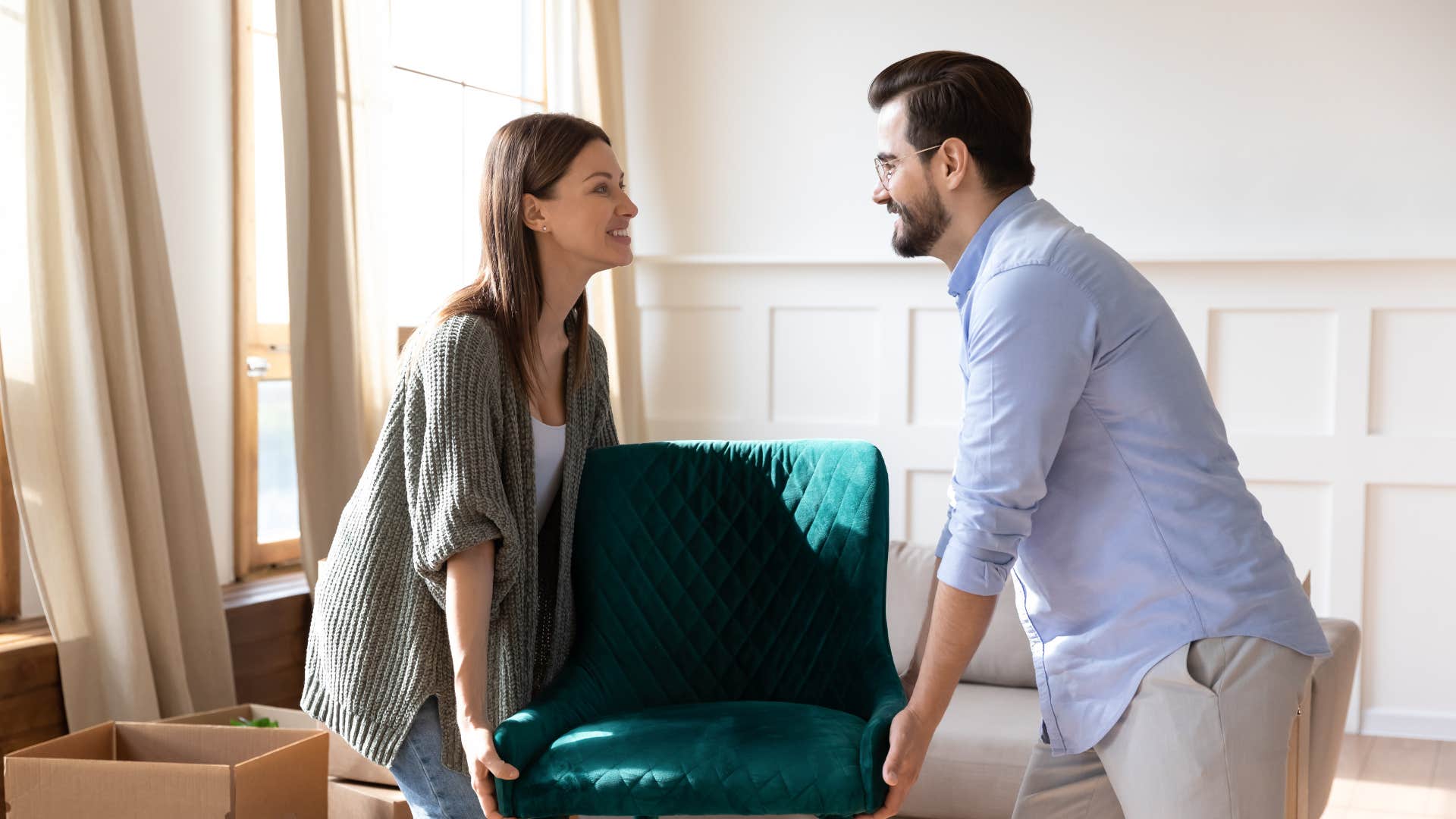 couple moving misplaced furniture for better feng shui