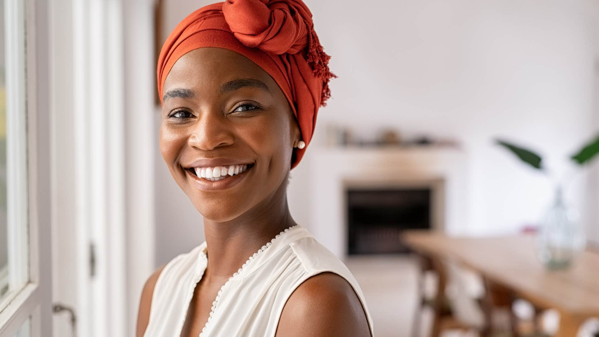 woman who avoids decorative rooms smiling at home