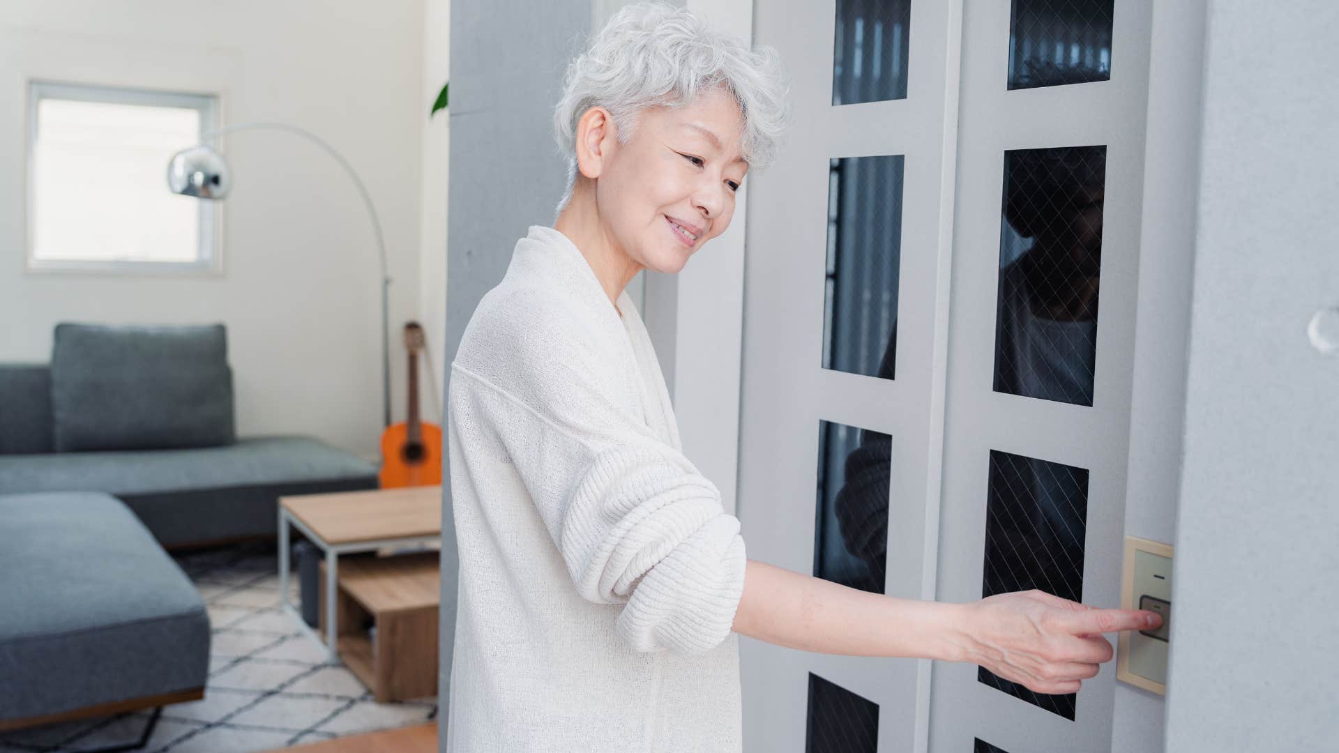 woman who has an elevator at home pushing the button