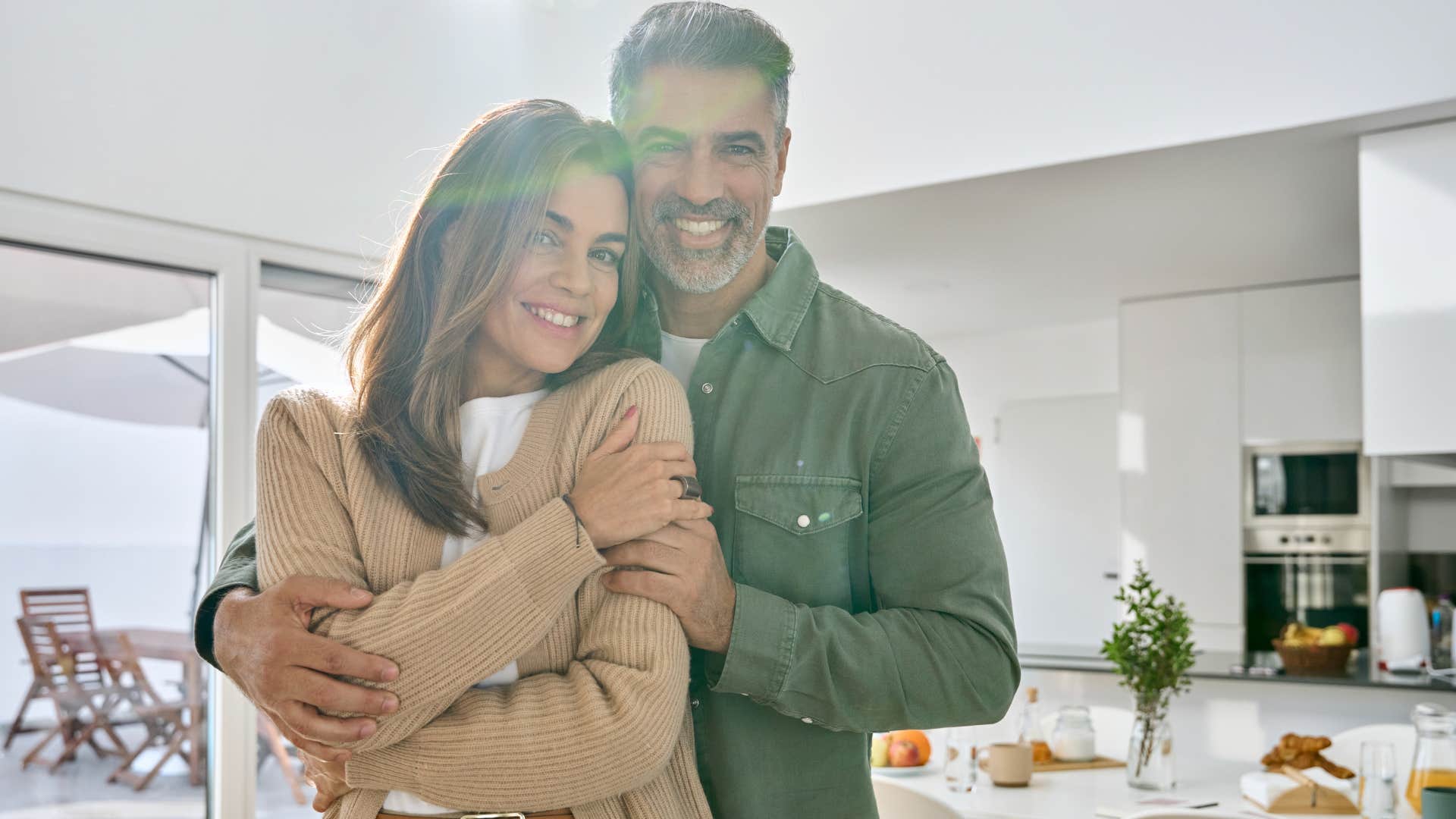 couple who uses more than one kitchen smiling at home