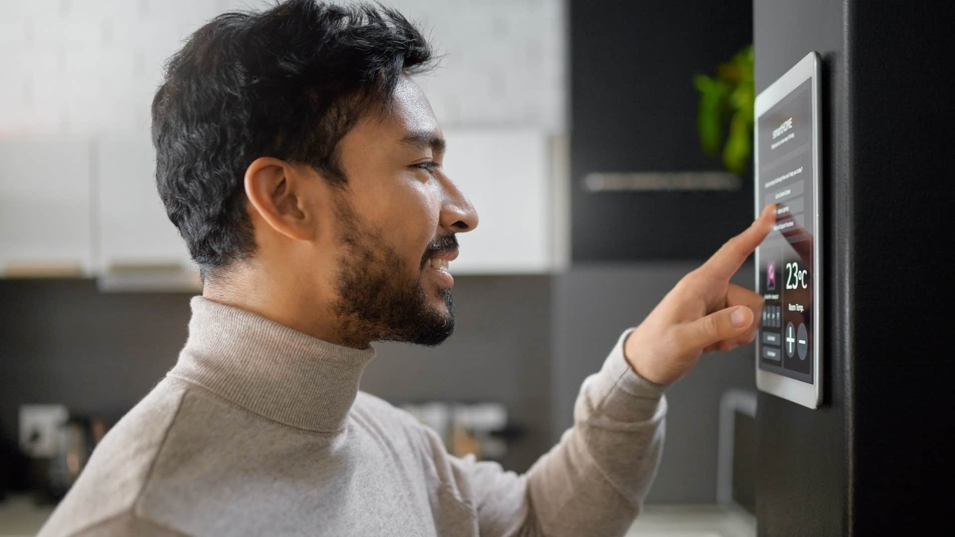 man using a private security system at home