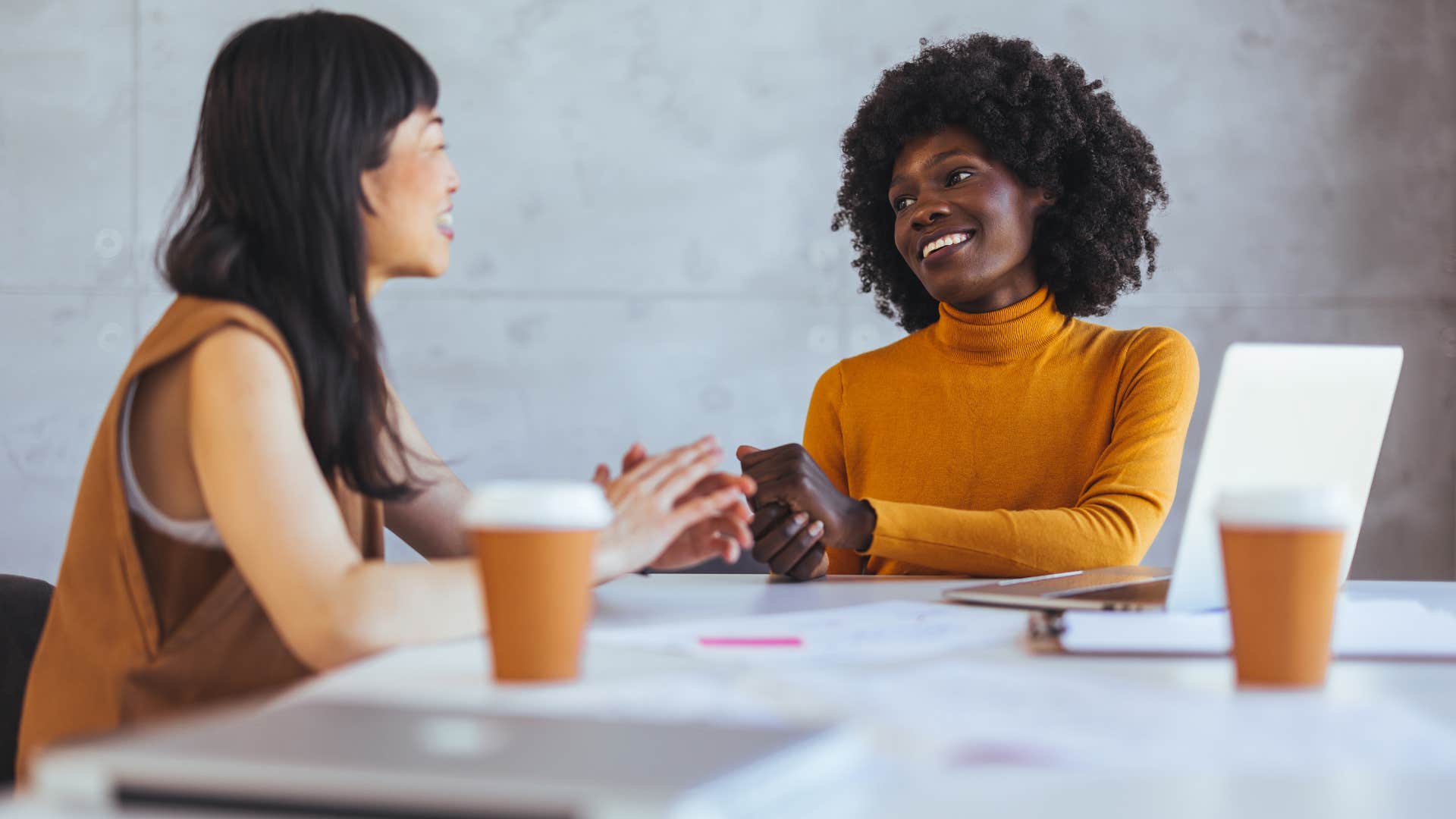 two women talking in office