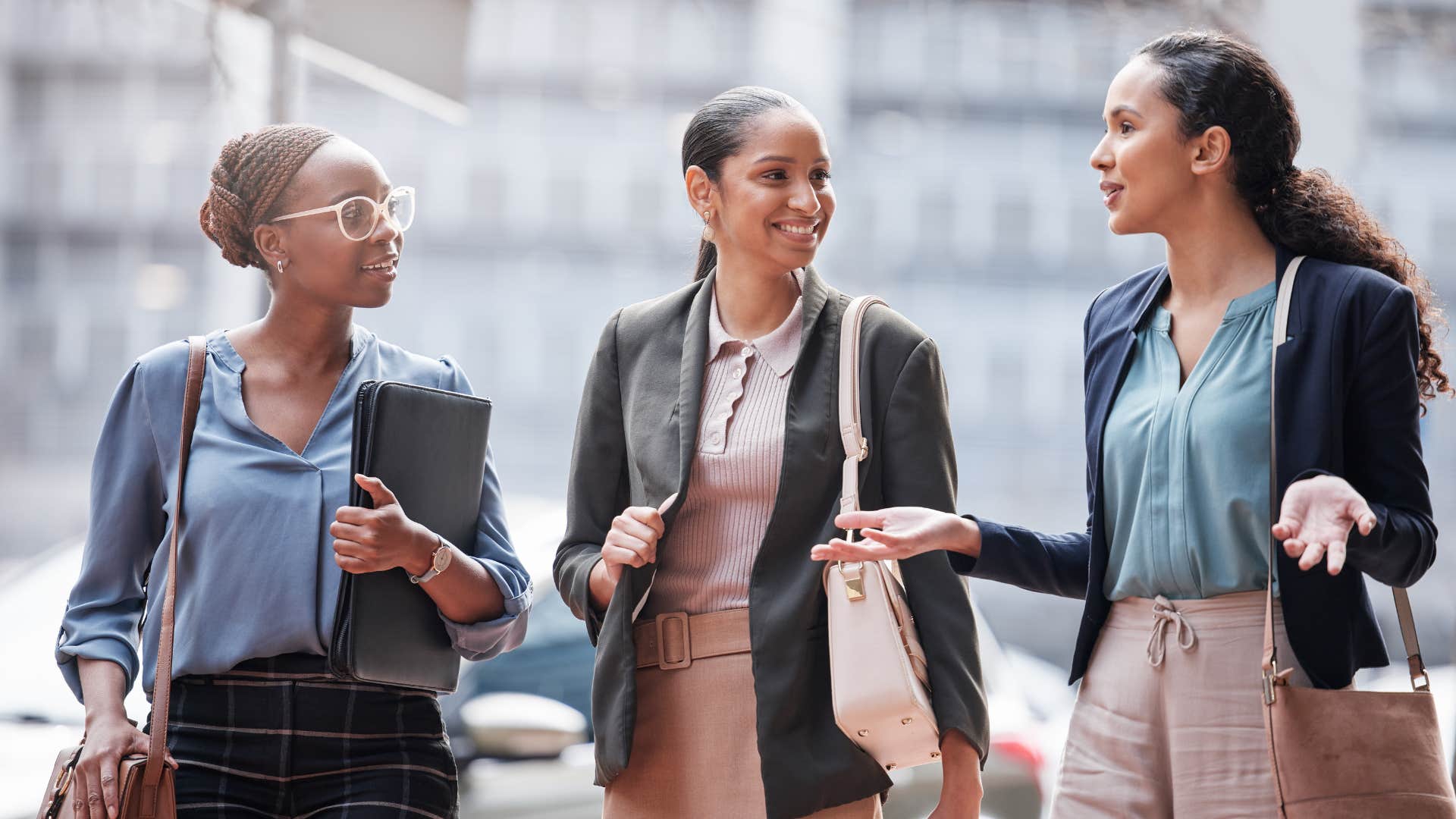 group of women walking down street talking