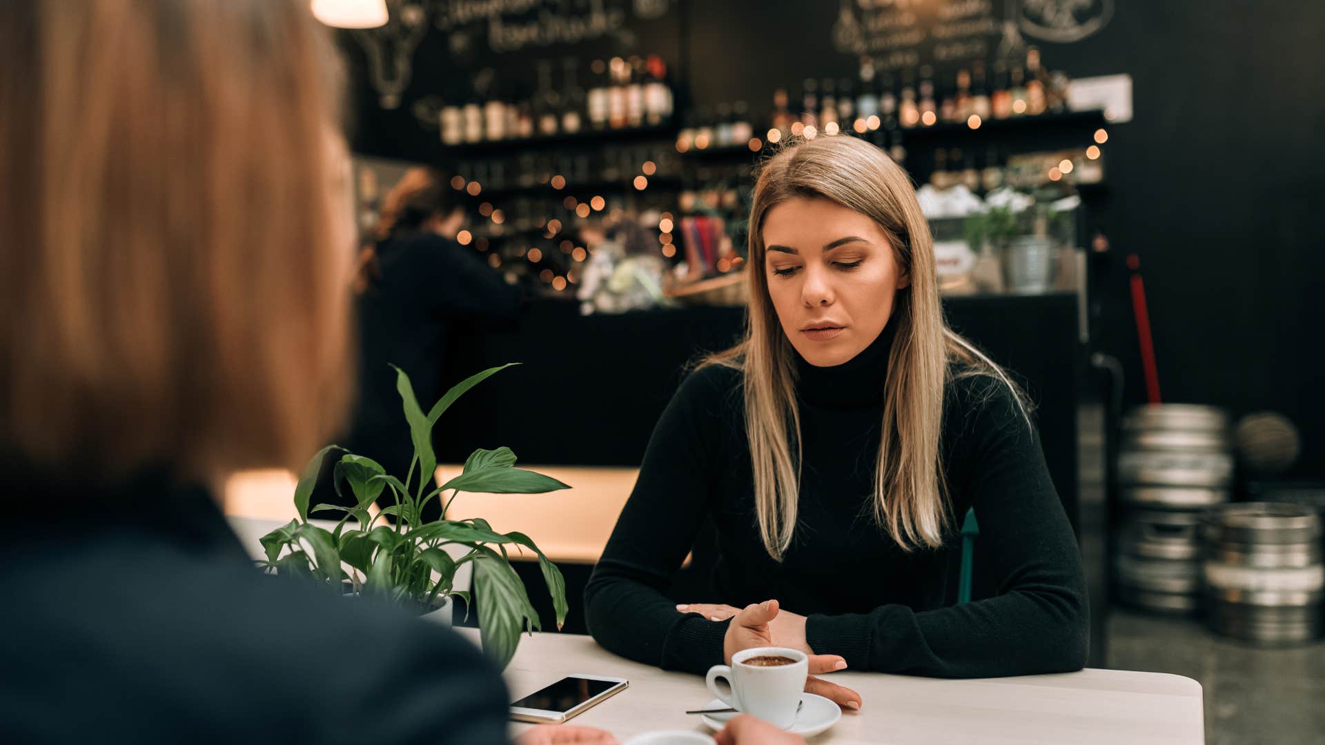 woman upset during conversation at dinner with friend