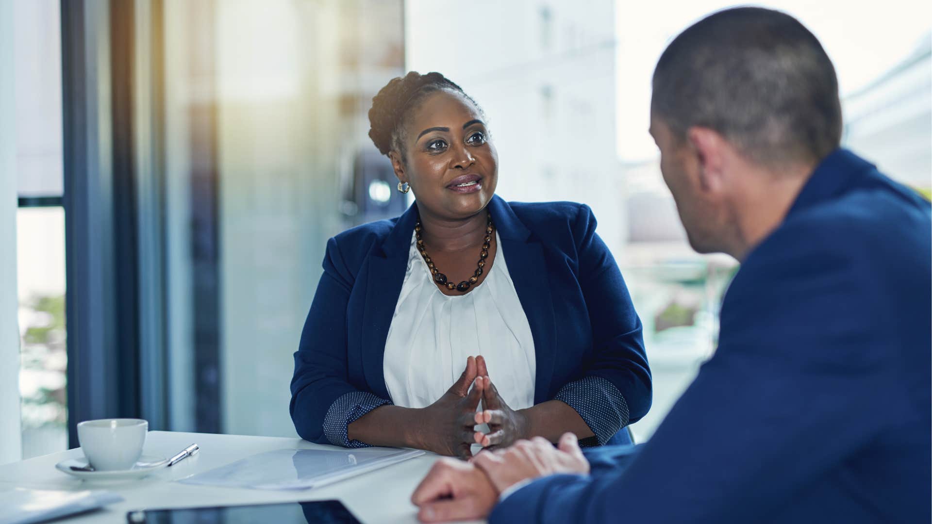 a woman recycles ideas with a client and presents it as new ones which he notices