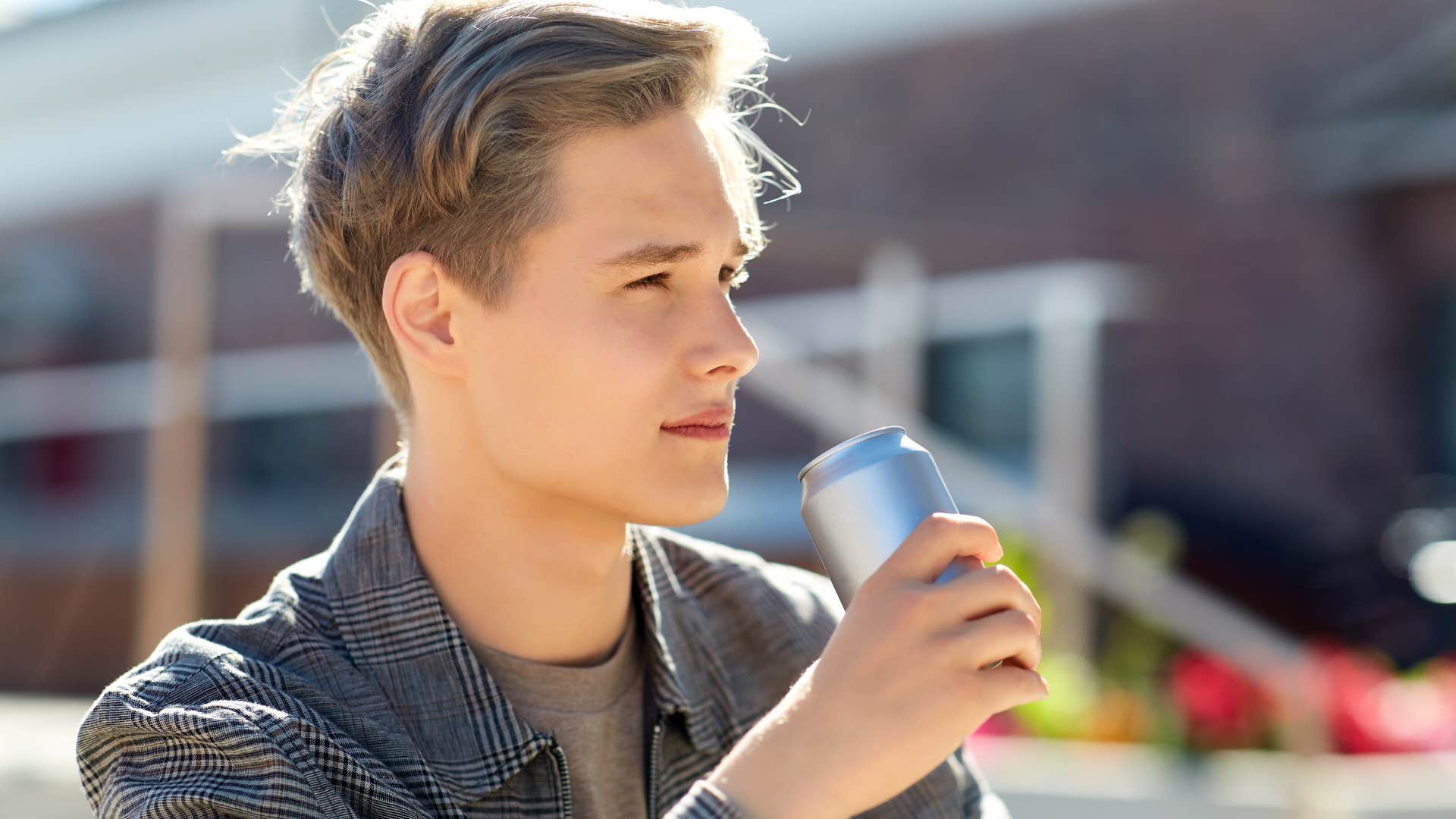 man drinking from a can