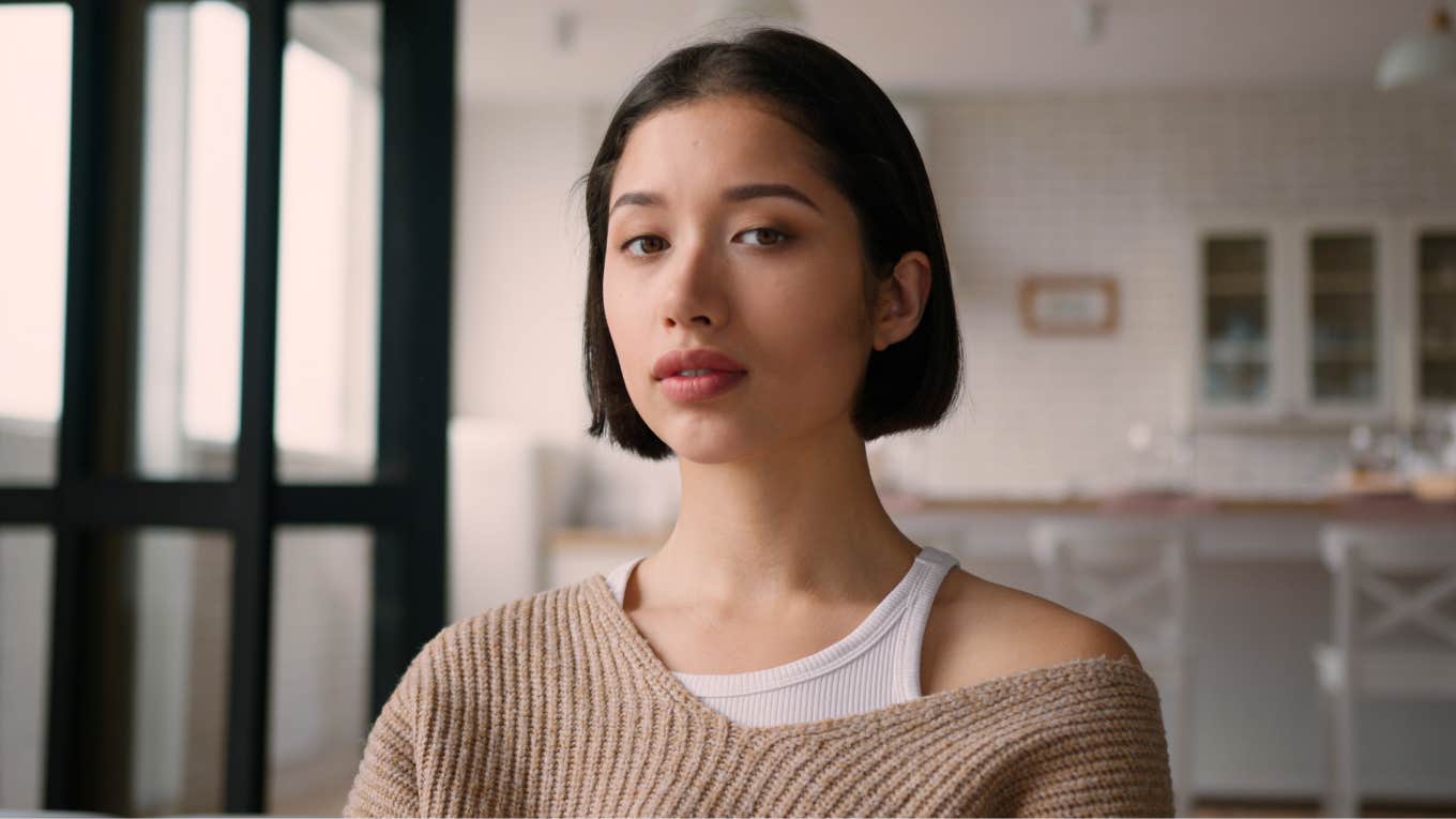 Things In Someone's Kitchen That Reveal They're Emotionally Unequipped For Adulthood young woman unequipped for adulthood sitting in her kitchen