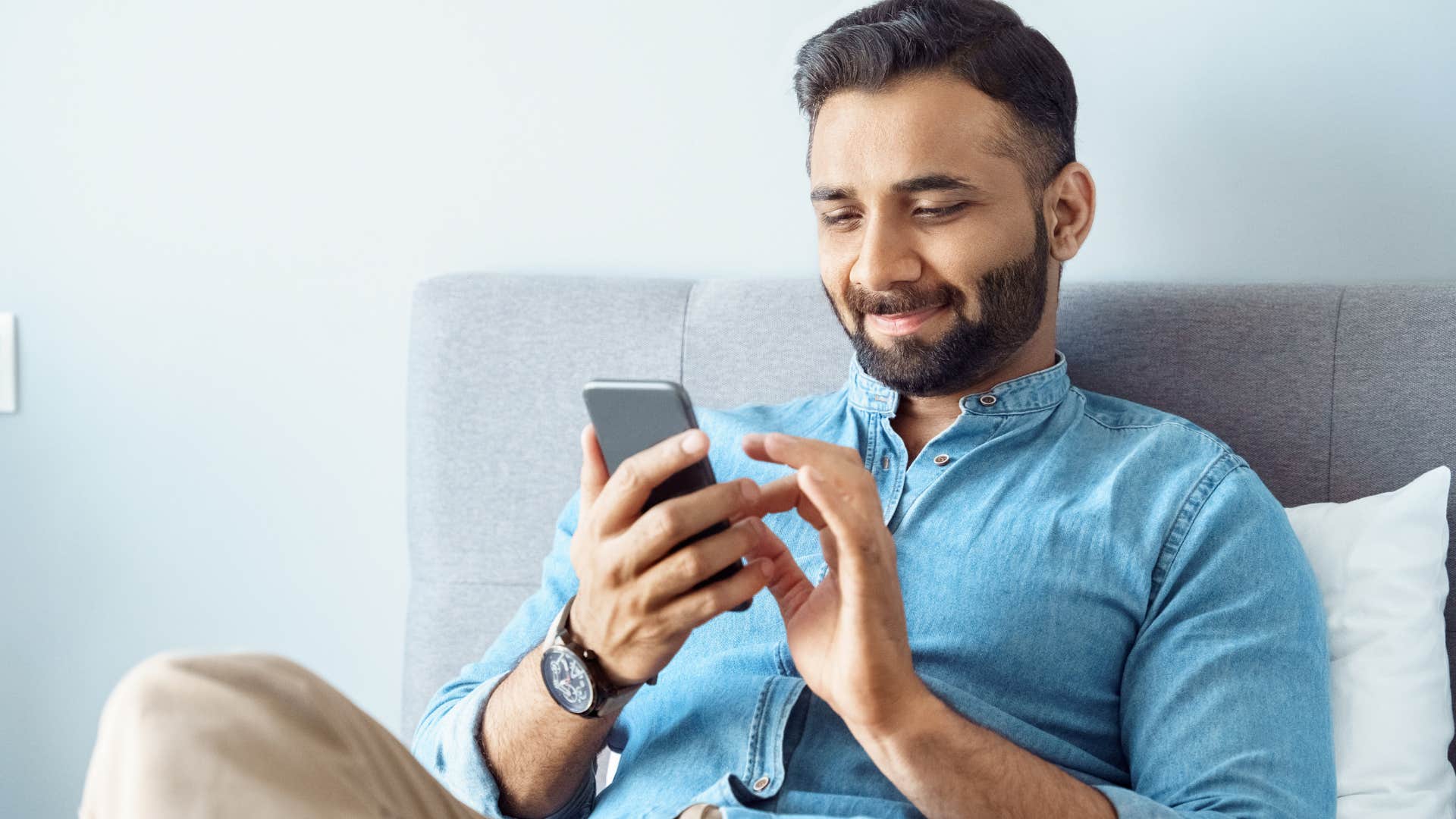 wealthy man embracing singlehood scrolling on his phone