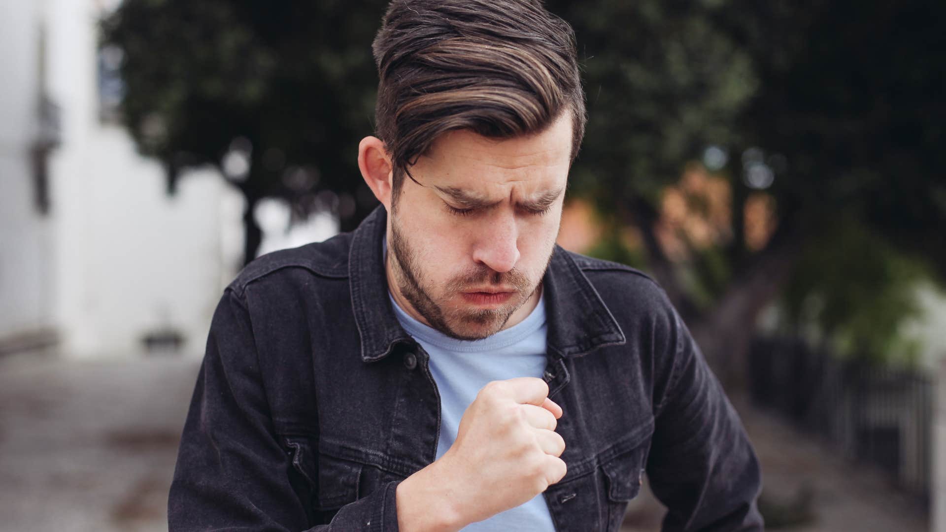 man not covering mouth while coughing