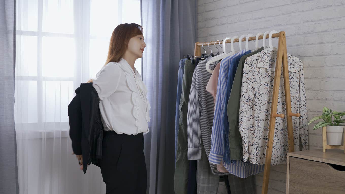 woman taking off coat