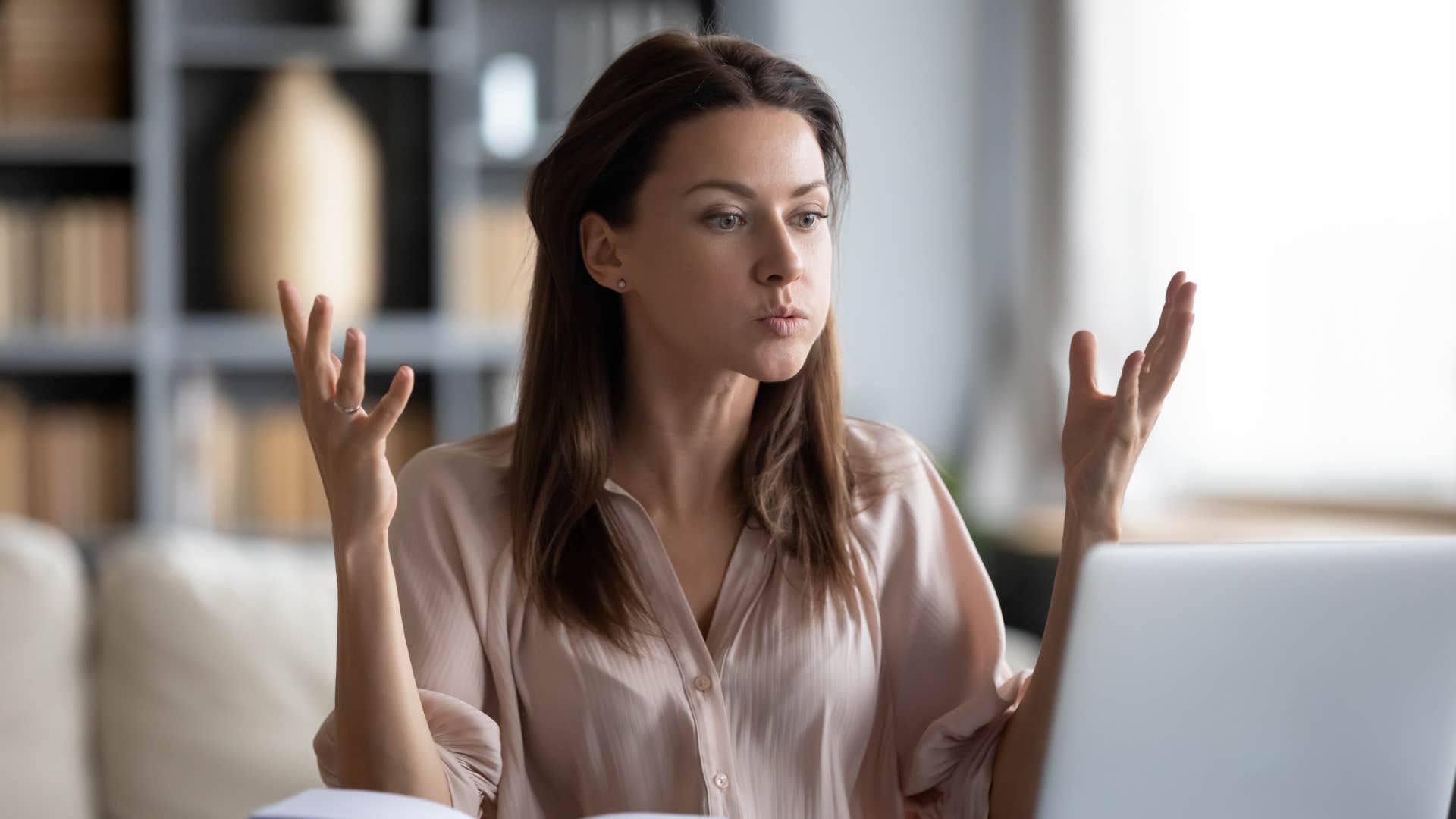 unhappy woman looking at laptop screen