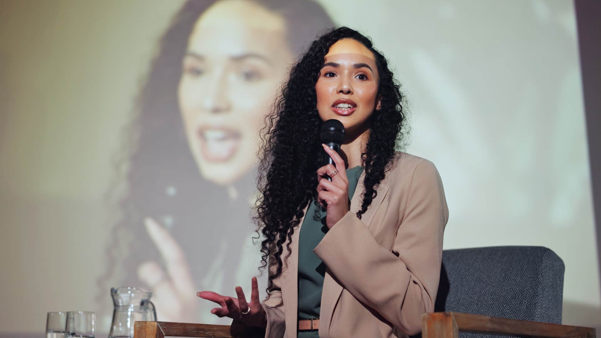 woman speaking at exclusive seminar